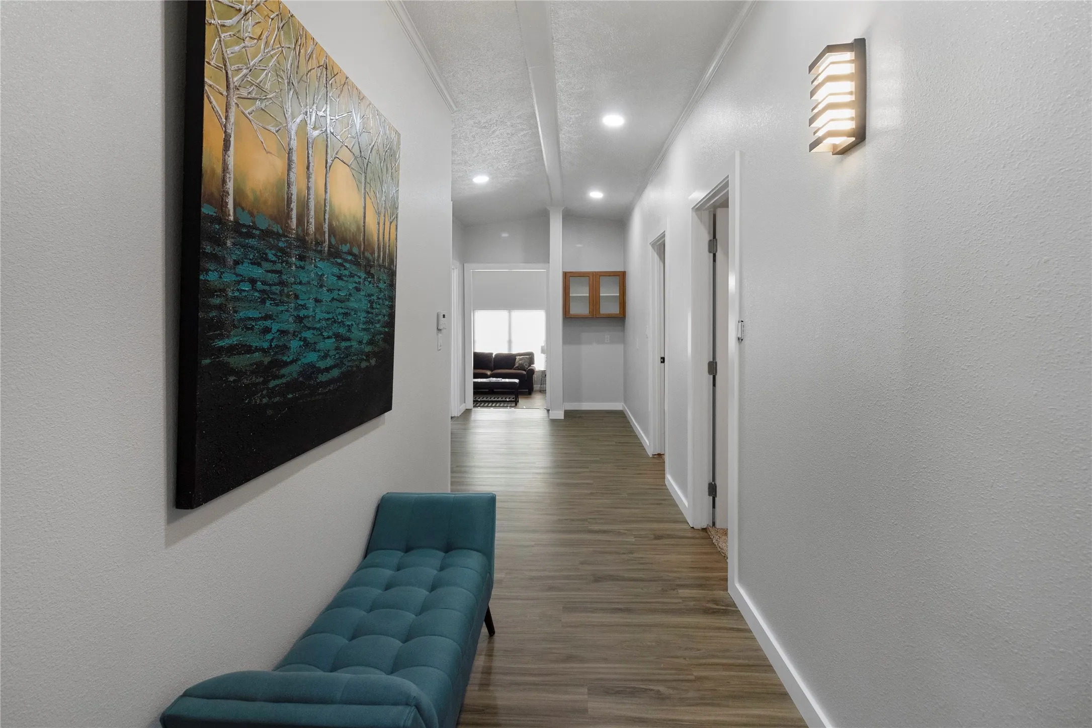 Hallway featuring wood-finish flooring, recessed lighting, and a vaulted ceiling