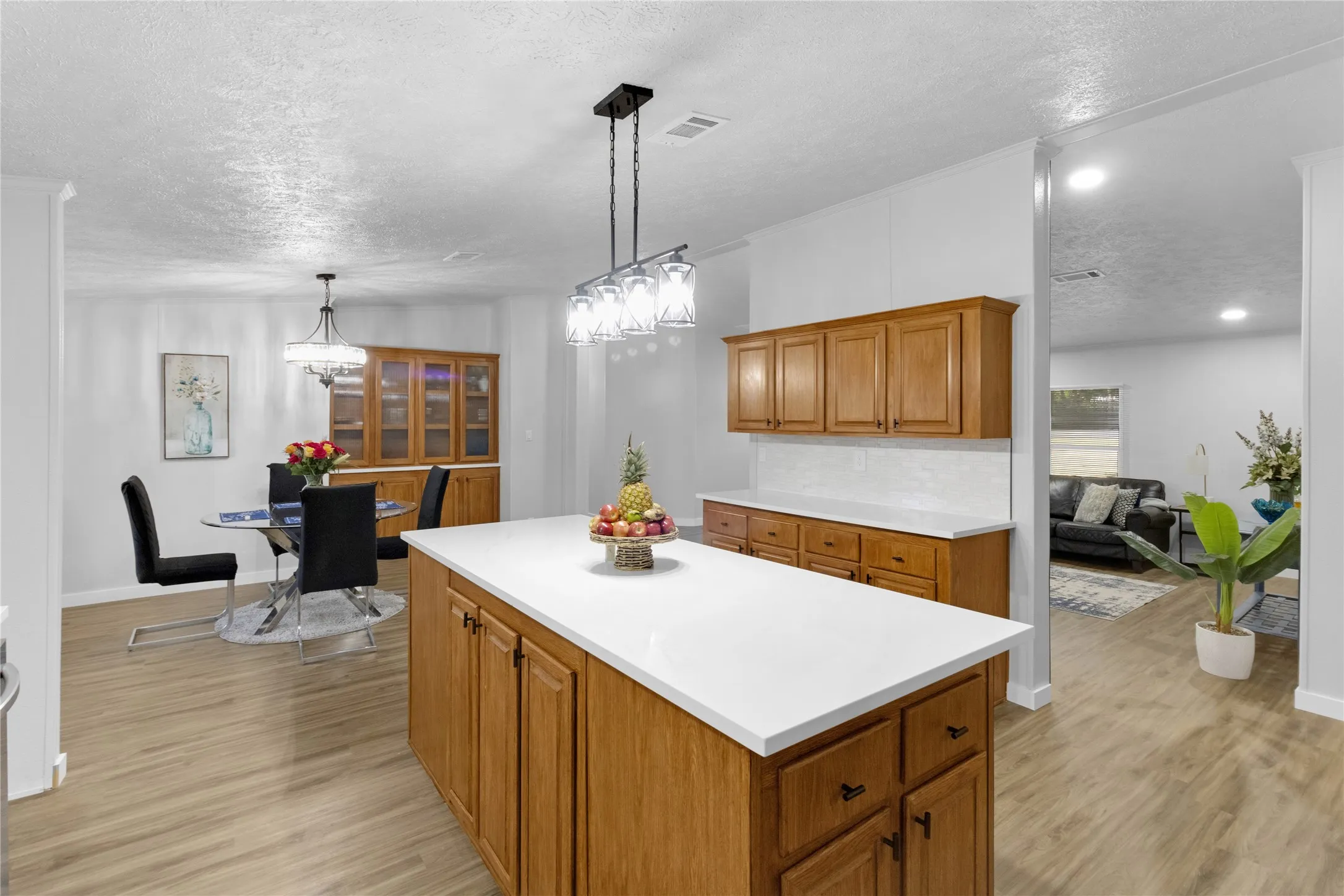 Kitchen island featuring a white countertop and wood-finish cabinetry