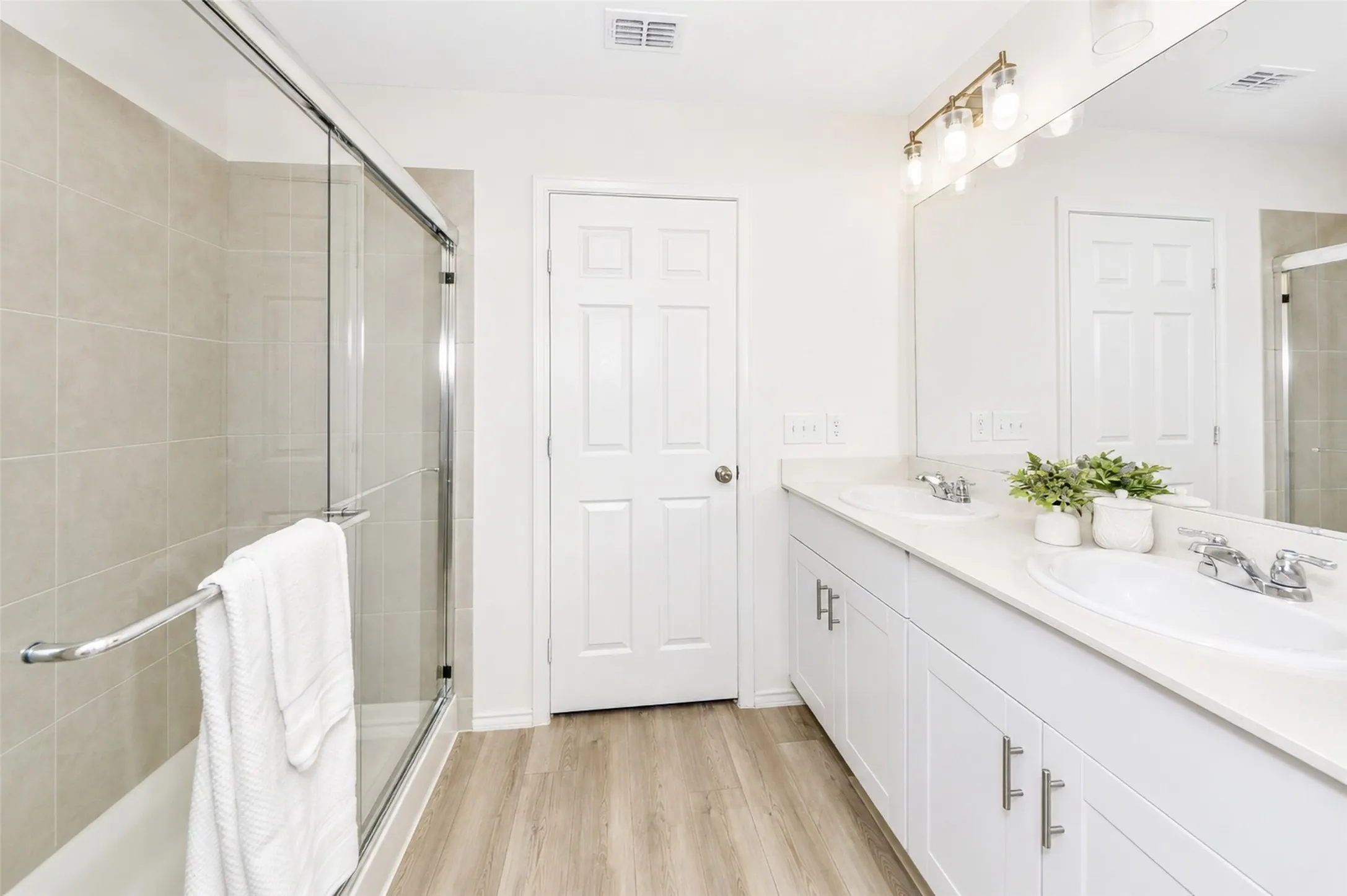 The primary bathroom has a separate stand up shower and bathtub, and dual sinks