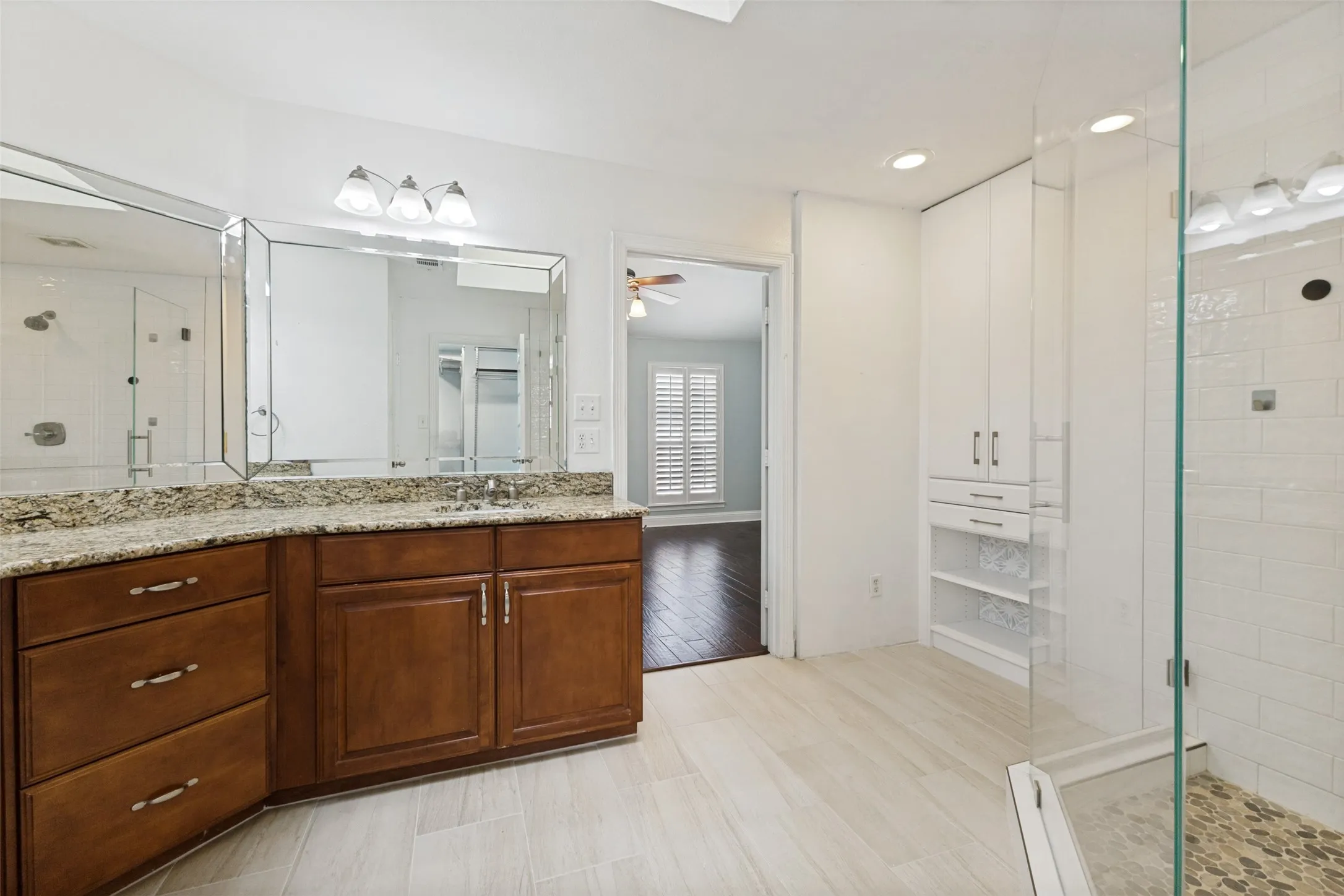 Dual sinks and a frameless shower in the primary bathroom