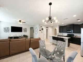 Open-concept living area featuring tile flooring and a ceiling fan