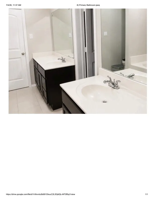 Dual vanity featuring white countertops, integrated sinks, chrome faucets, and dark wood-finish cabinetry