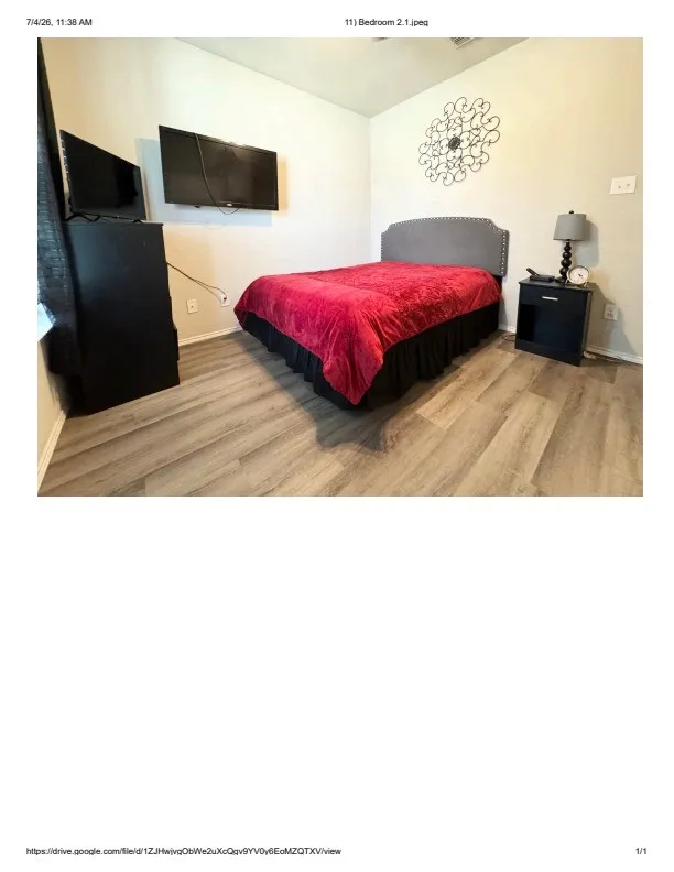 Room with light-toned wood-finish flooring and neutral wall paint