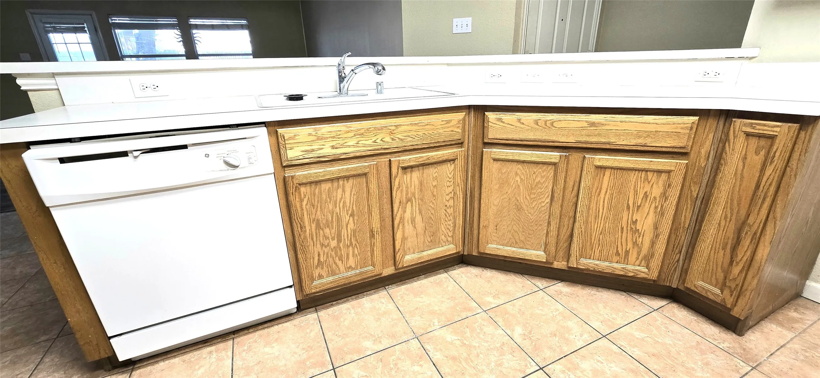 L-shaped countertop with an integrated sink and gooseneck faucet
