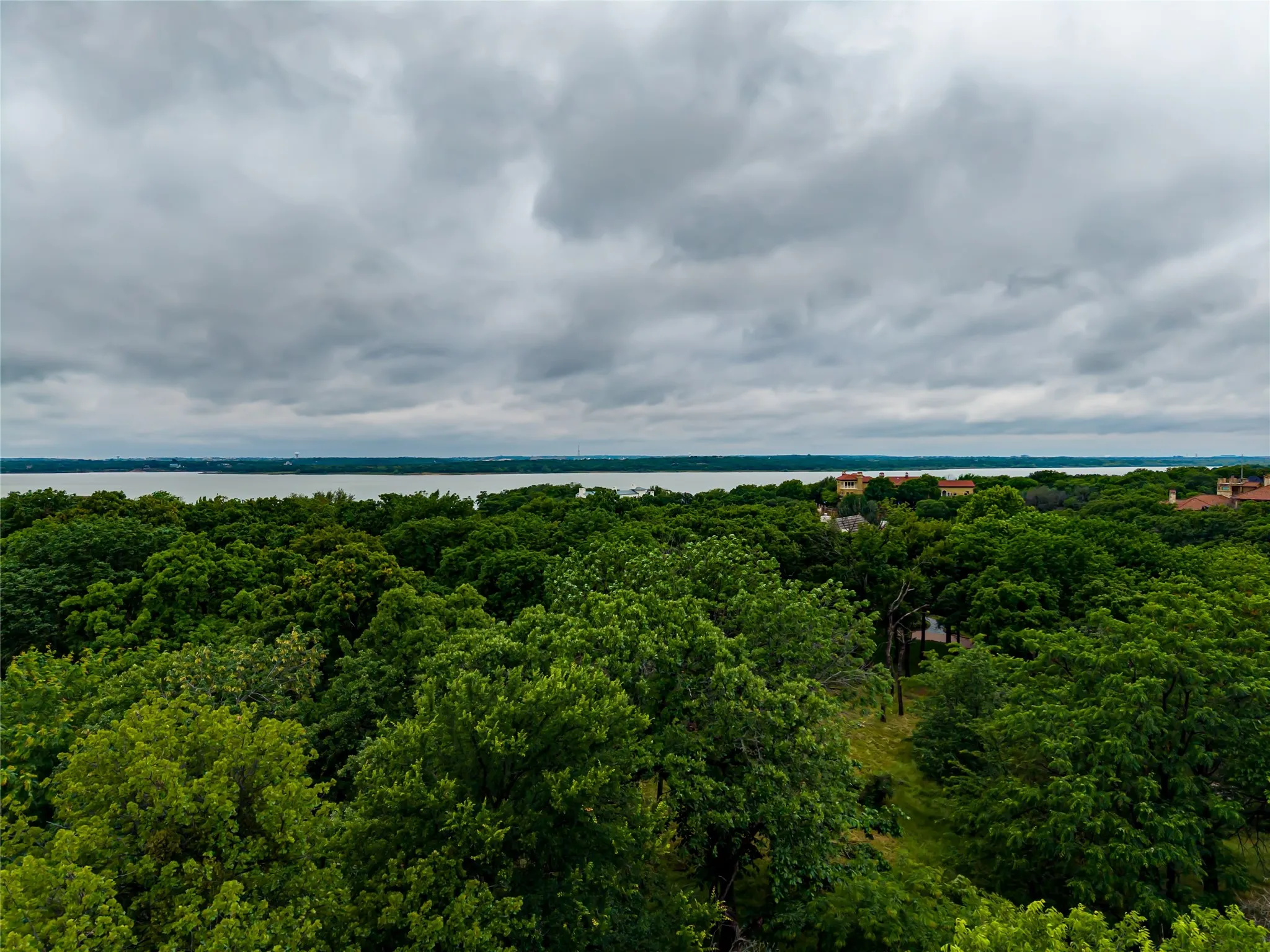 Elevated homesite view with the distant lake visible on the horizon