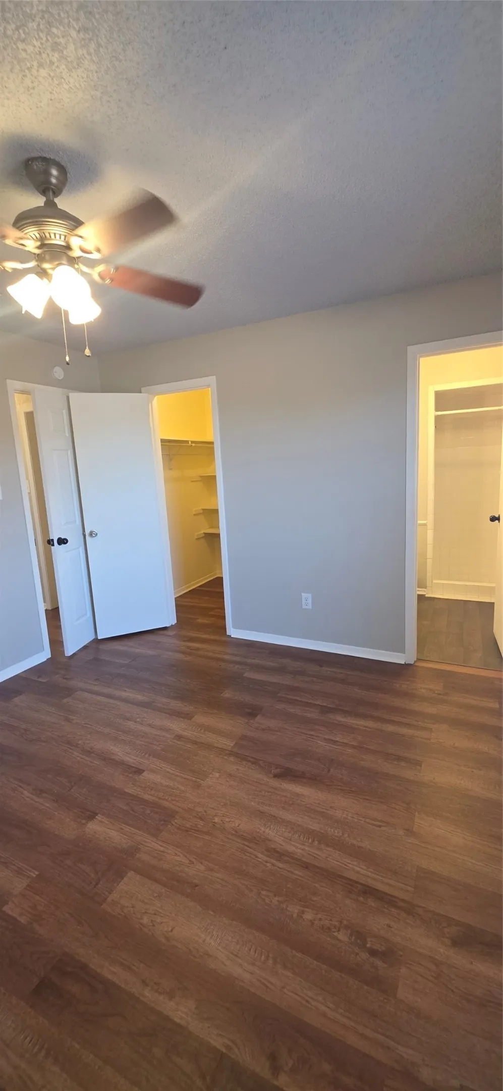 Wood-finish flooring, ceiling fan with integrated lighting, dual closets with interior shelving