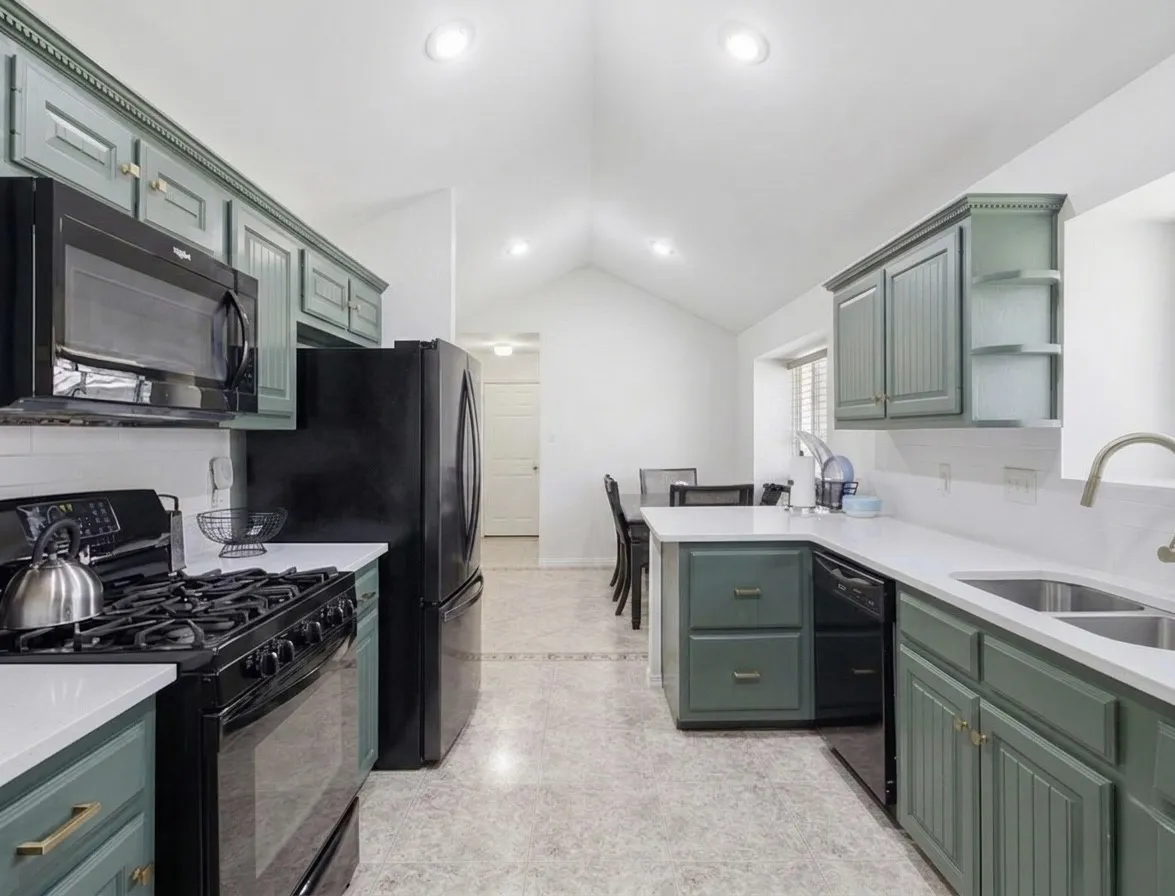 BEAUtiful kitchen with popular green cabinetry with a touch of gold for the hardware! Gas stove on home for great cooking!