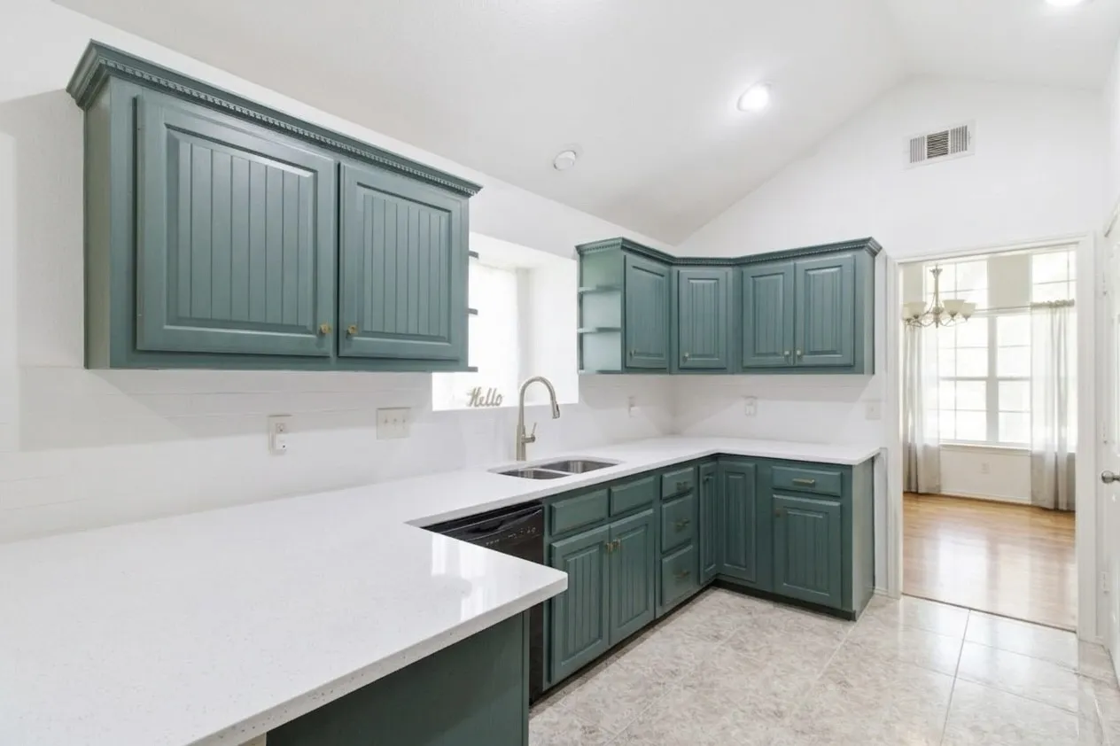 BEAUtiful kitchen with amazing storage behind the popular green cabinetry!