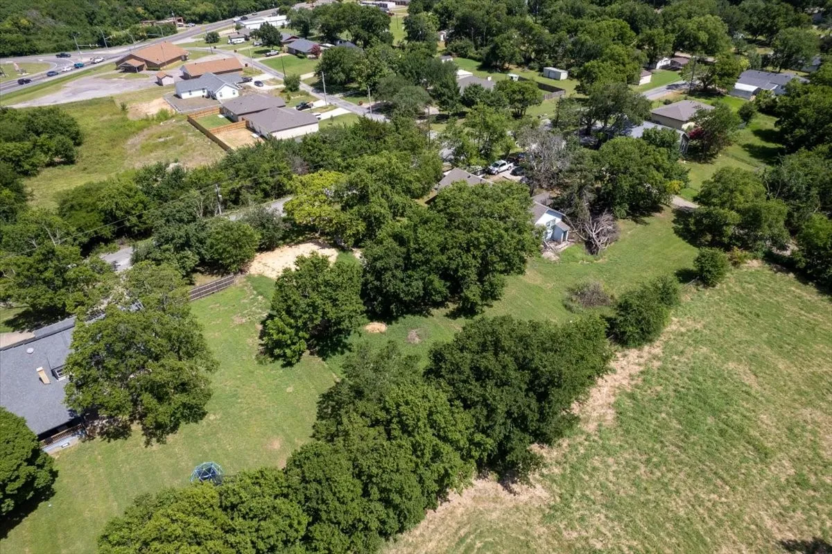 lot among neighboring homes and mature trees