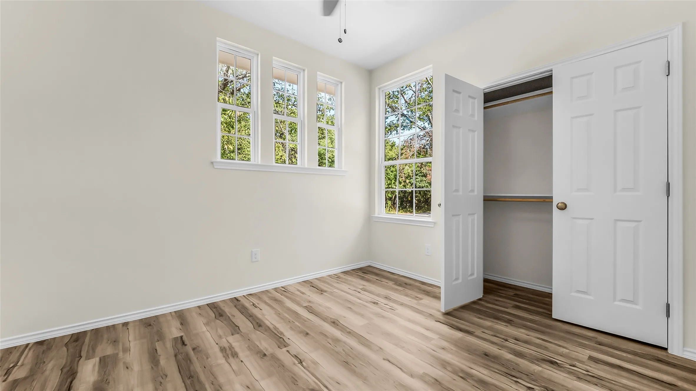Wood-finish flooring with light-colored walls and white trim
