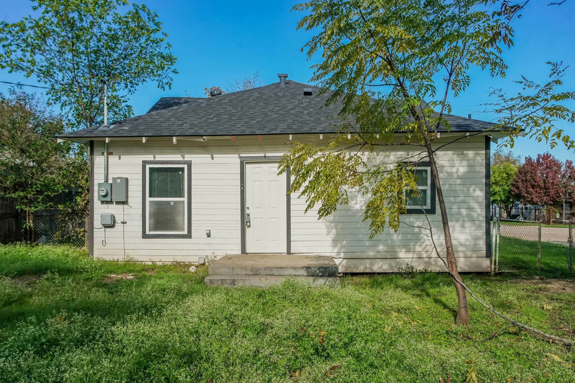 White exterior siding with dark trim accents