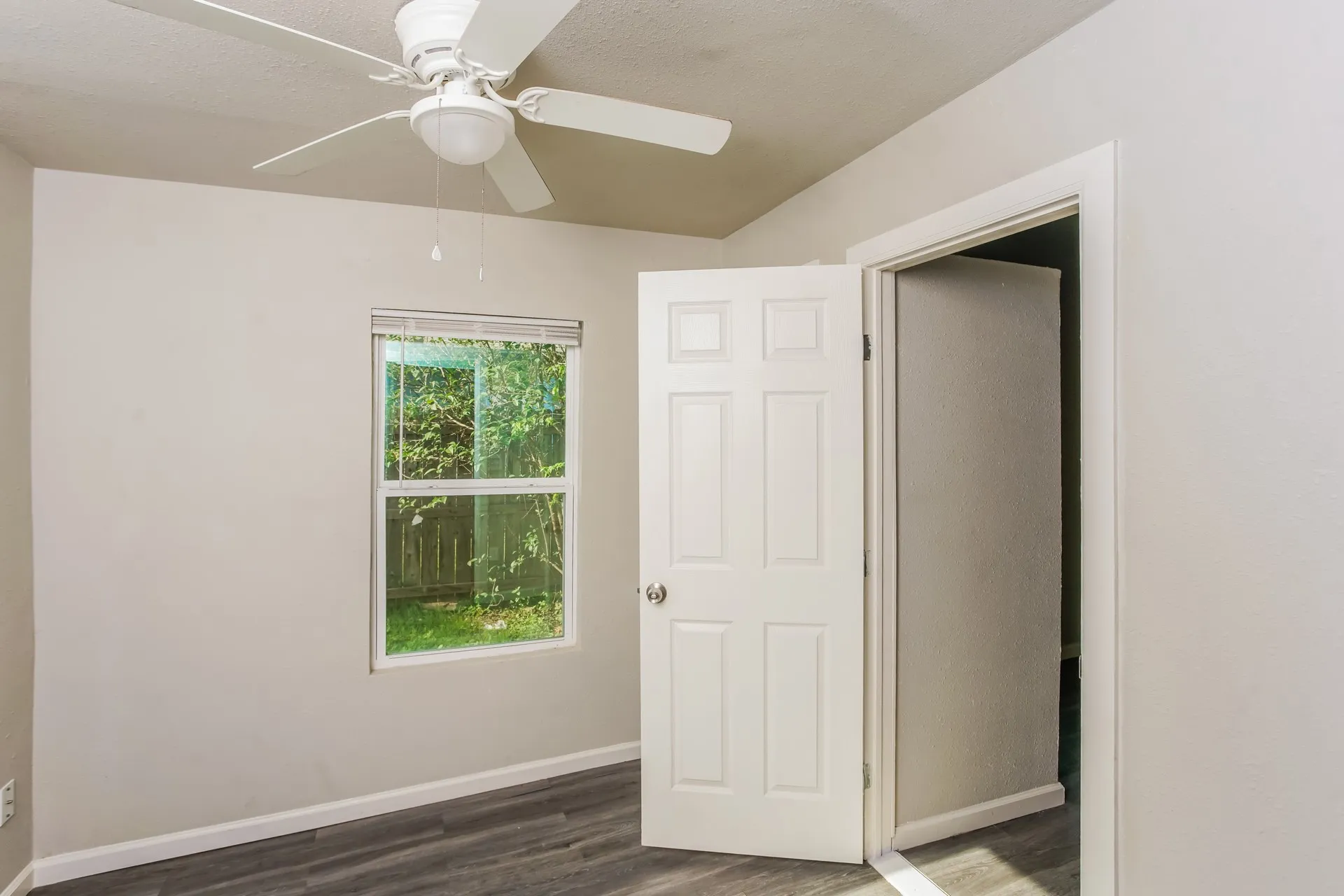 Room featuring light gray painted walls and wood-finish flooring