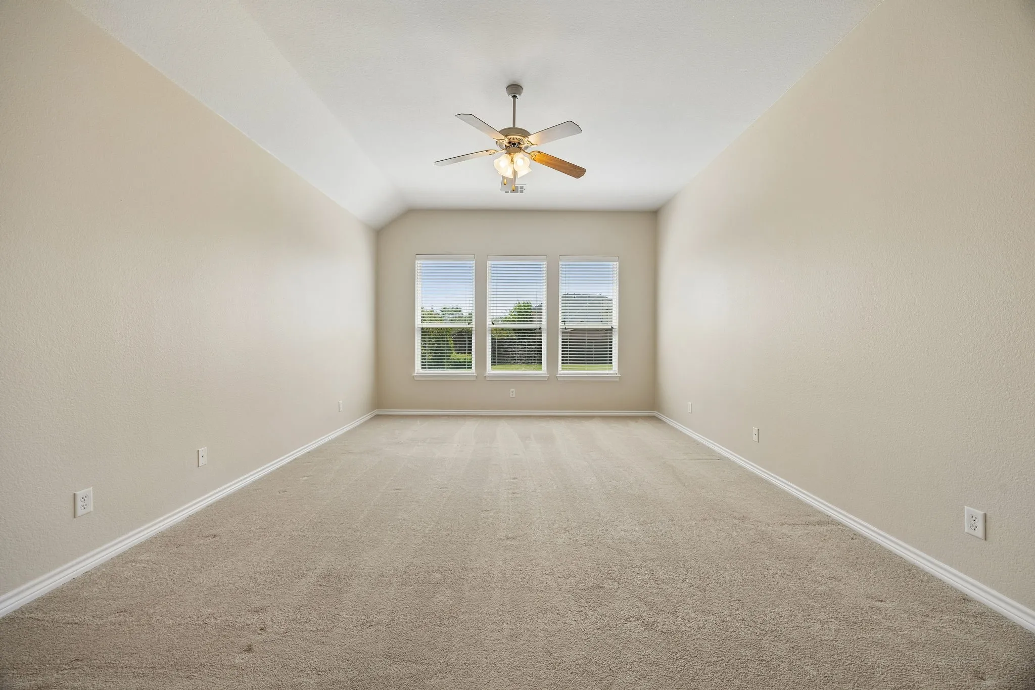 Another view of large primary suite overlooking gorgeous backyard.