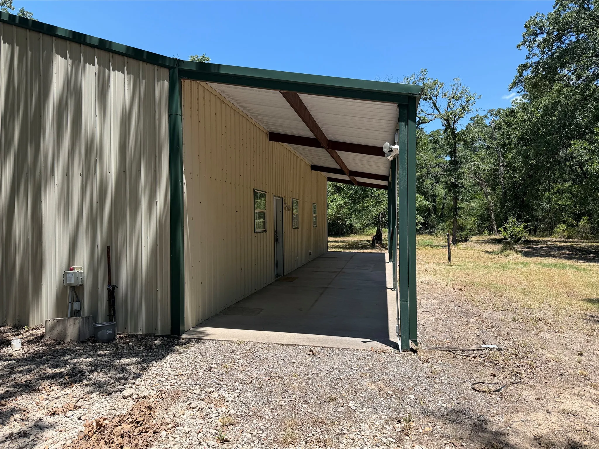 Covered Patio runs full length of Barndominium.  Large size for creating a great outdoor living space for enjoying nature, sunrises, cookouts, or anything that makes a home your happy place in the country.