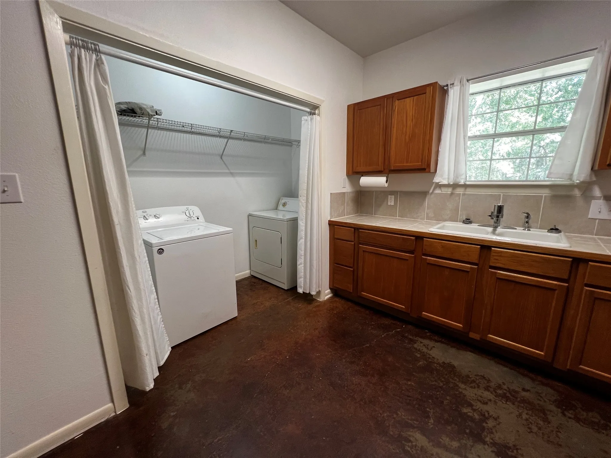 Kitchen and utility - pantry closet view from open living room.  Living room is adequate size for a dining and living area while the kitchen is spacious enough for a kitchen island.