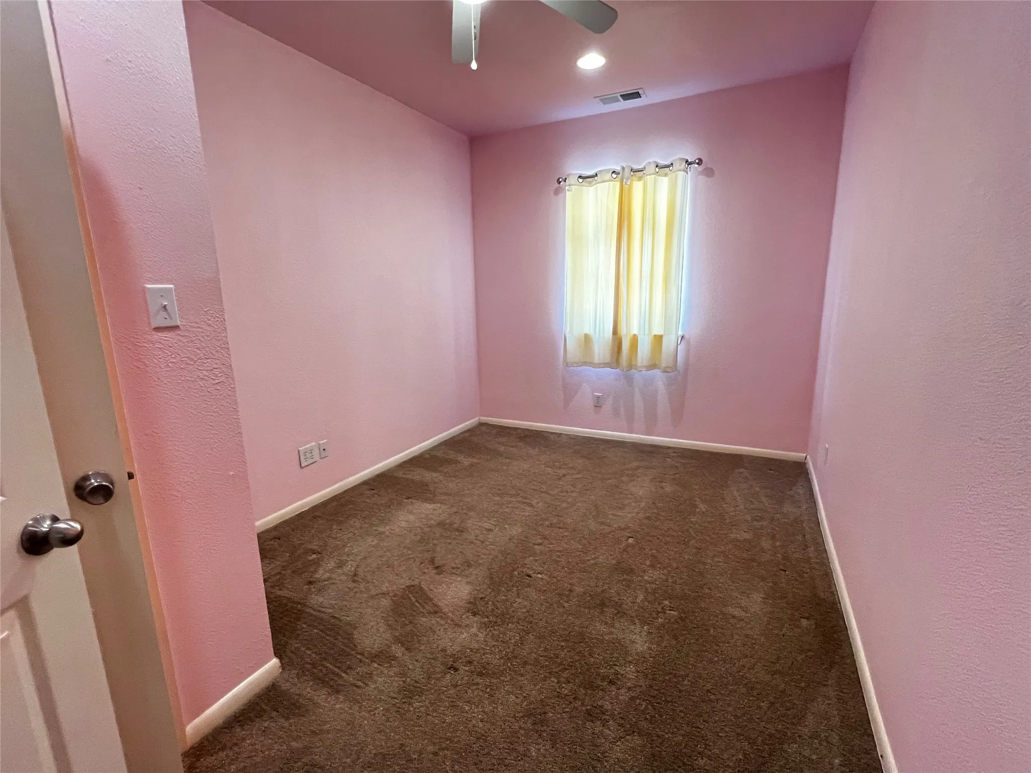 Bedroom #2 with carpet flooring, a window with curtains, walk-in closet, and a ceiling fan