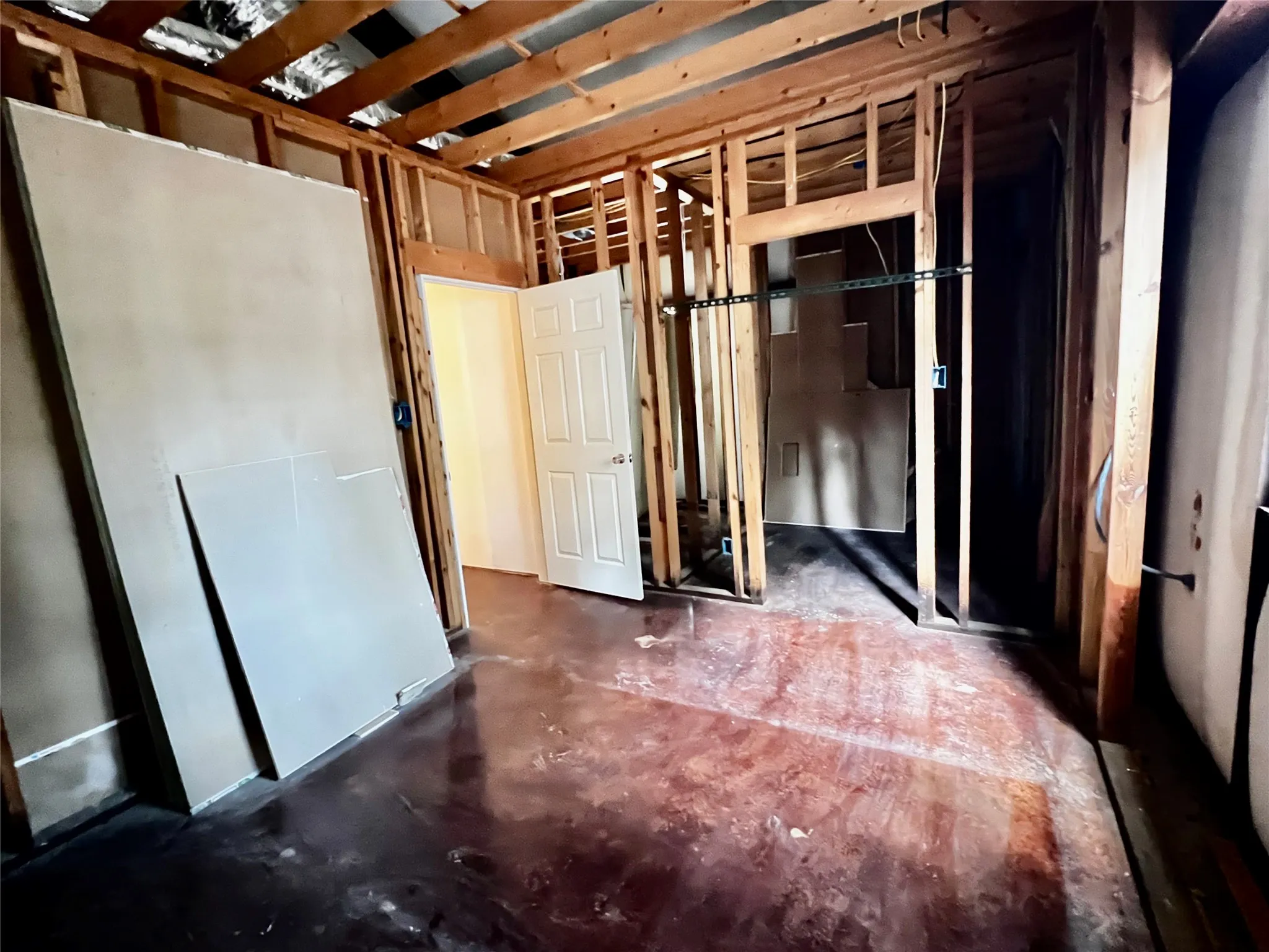 Bedroom #3 unfinished showing open entry door from hallway and entry to walk-in closet.