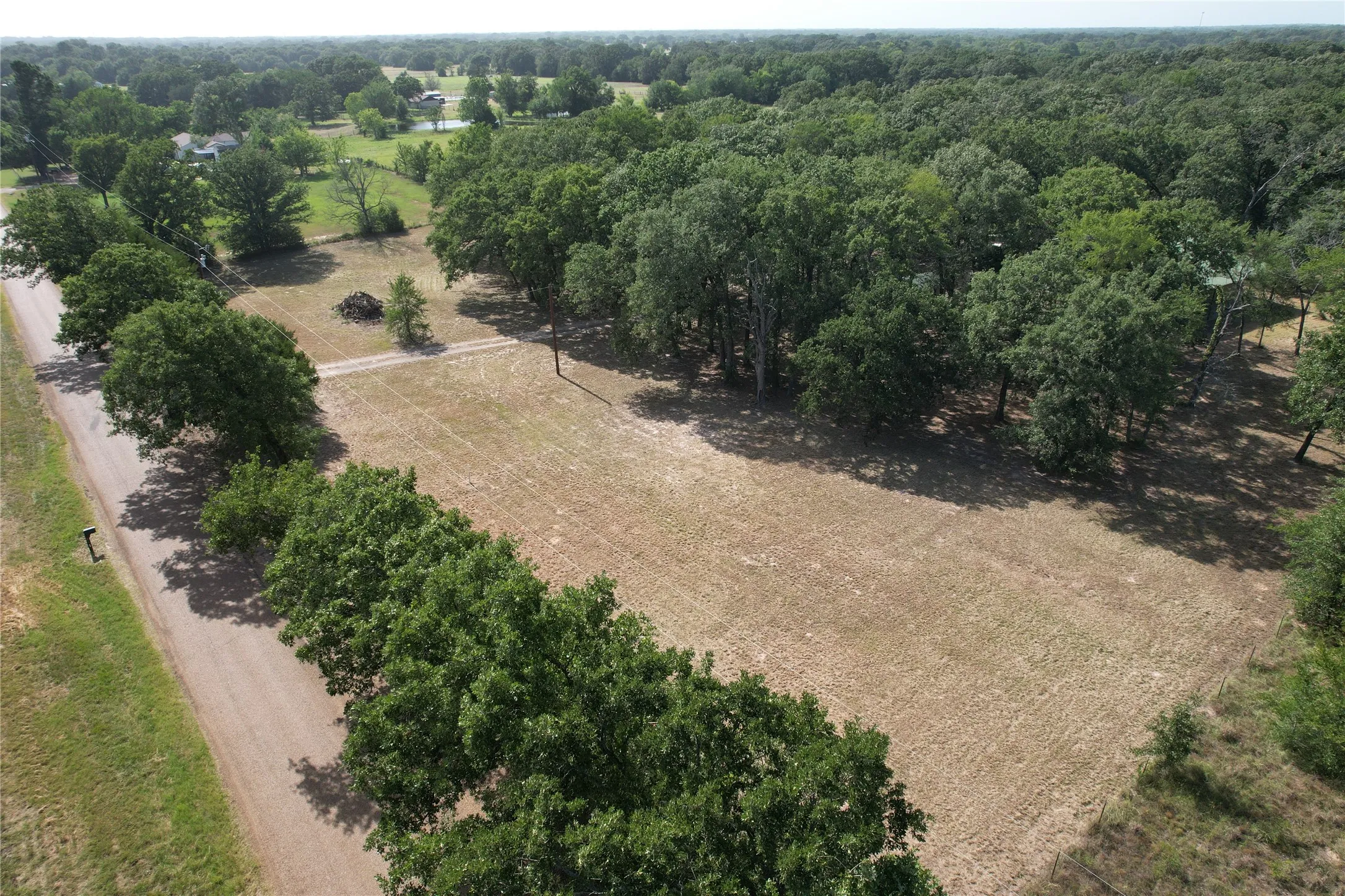 View from County Road 4068 and the Southeast corner of the property towards the Northwest.