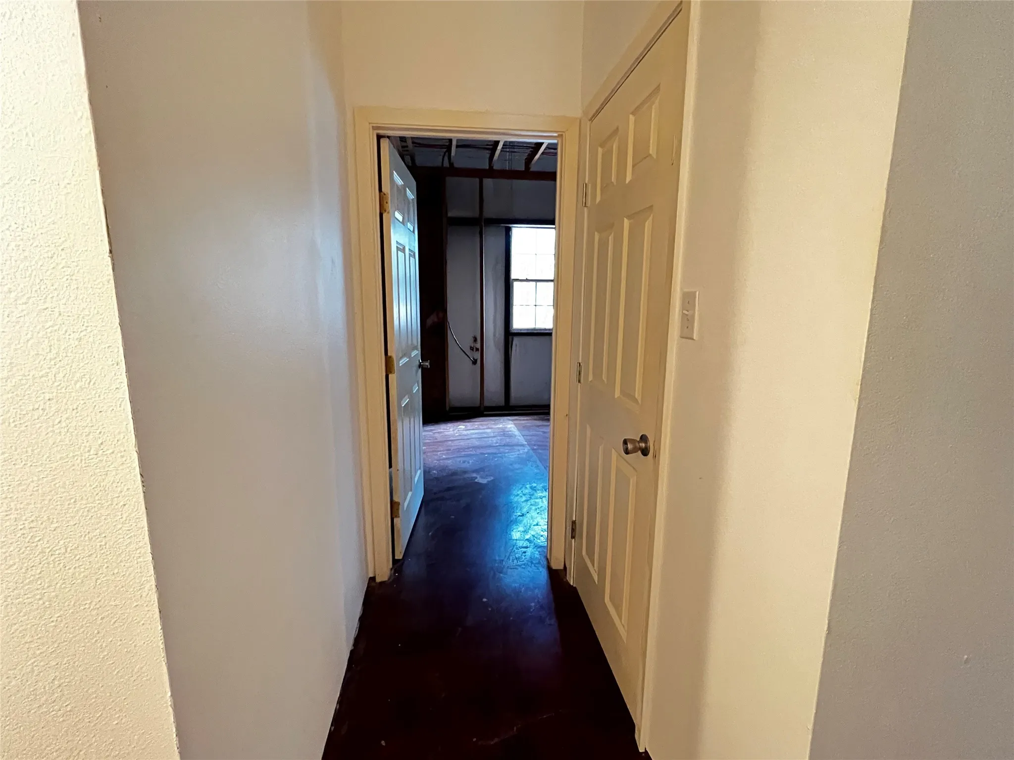 Hallway to Bedroom #3 unfinished.  Bathroom #2 Door is framed up behing the sheetrock on the left.  Door on the right is a closet.