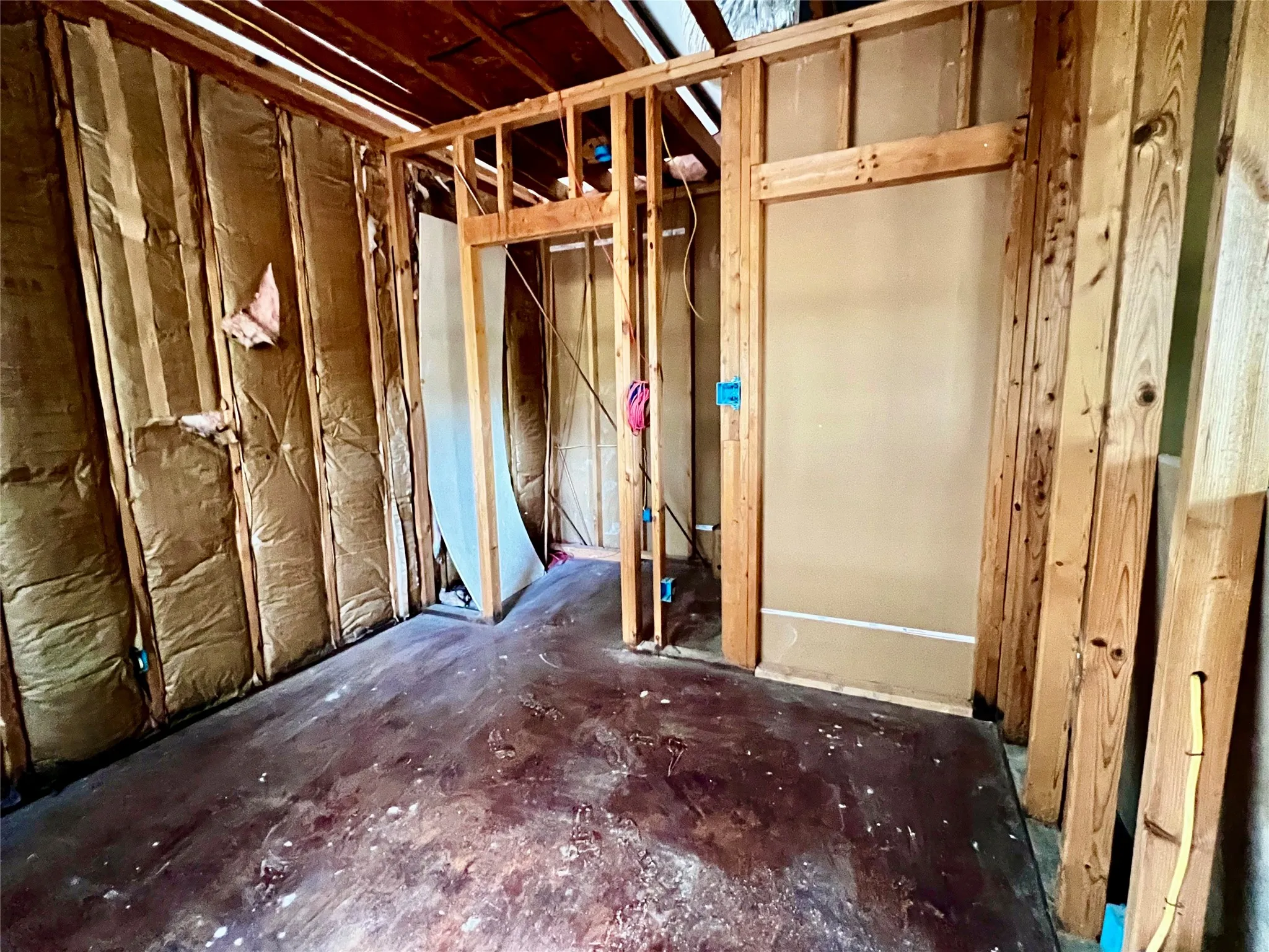 Bedroom #4 unfinished showing entry to walk-in closet and framed entry door.  Hallway to this bedroom is in the Living Room parallel to the Bedroom #3 entry hallway.