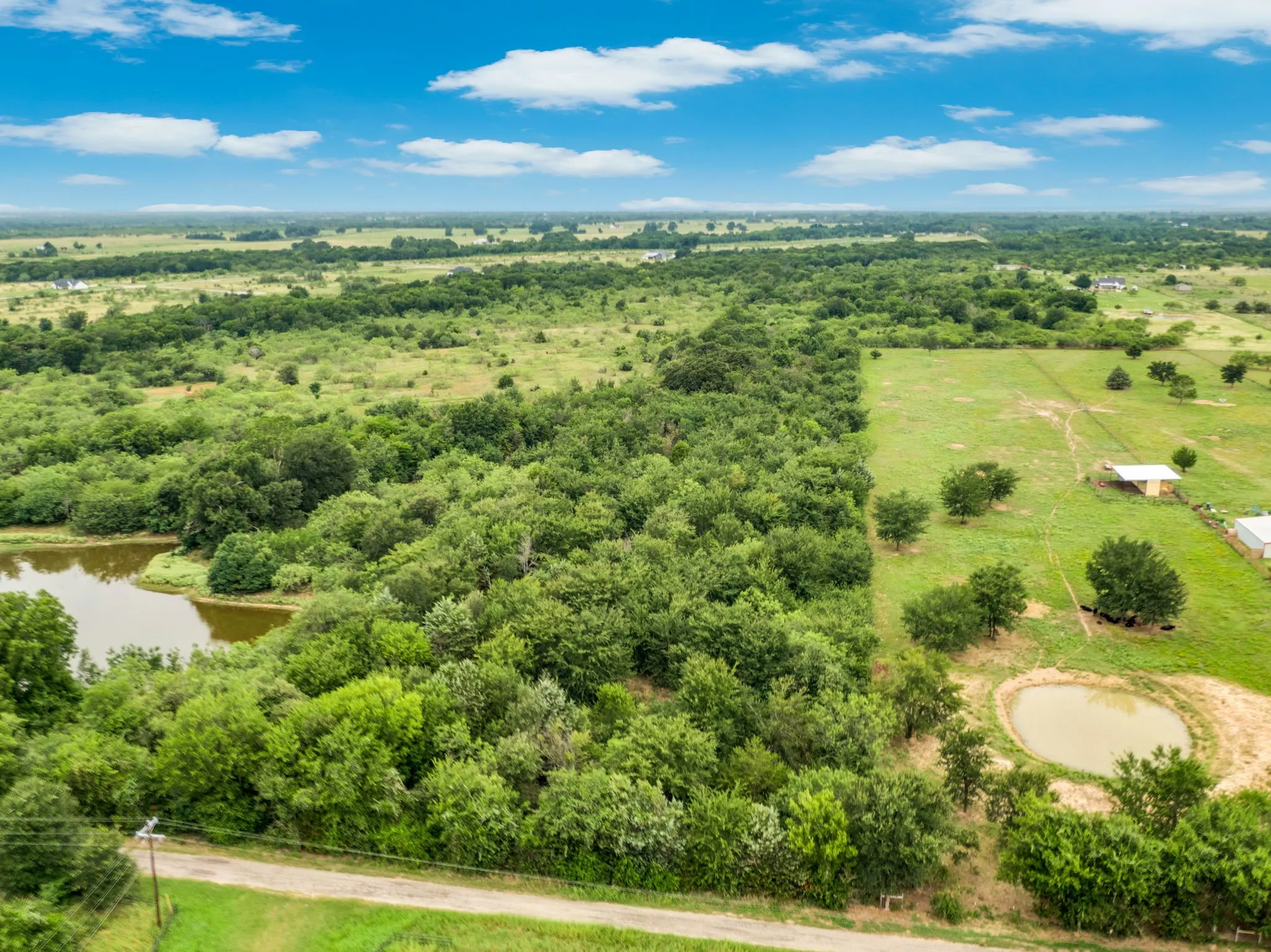 Expansive undeveloped land featuring a combination of dense tree cover and open grassy areas