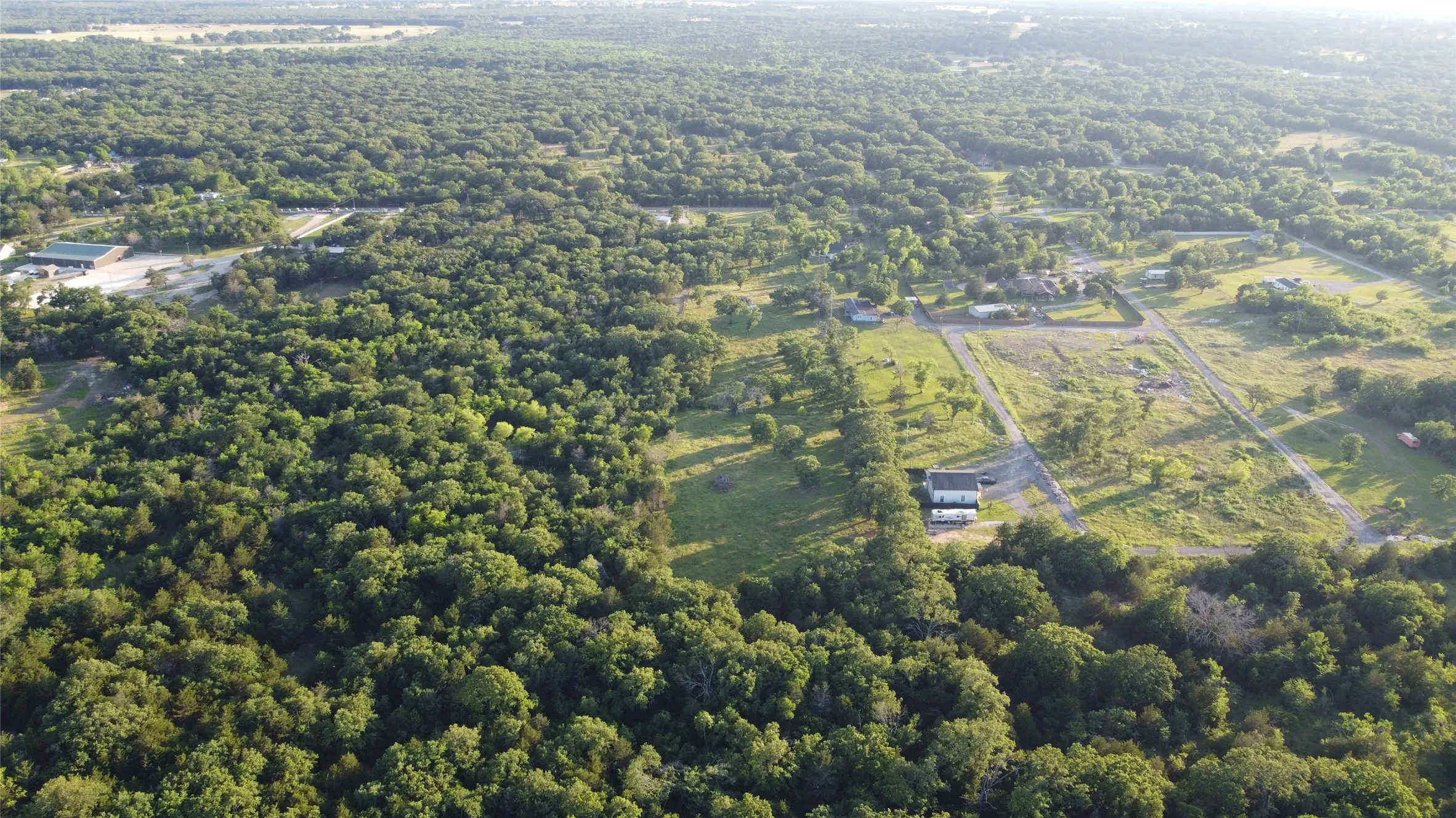 Expansive wooded acreage featuring significant tree coverage and clearings