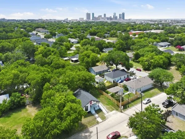 Aerial perspective showcasing residential properties with a distant cityscape