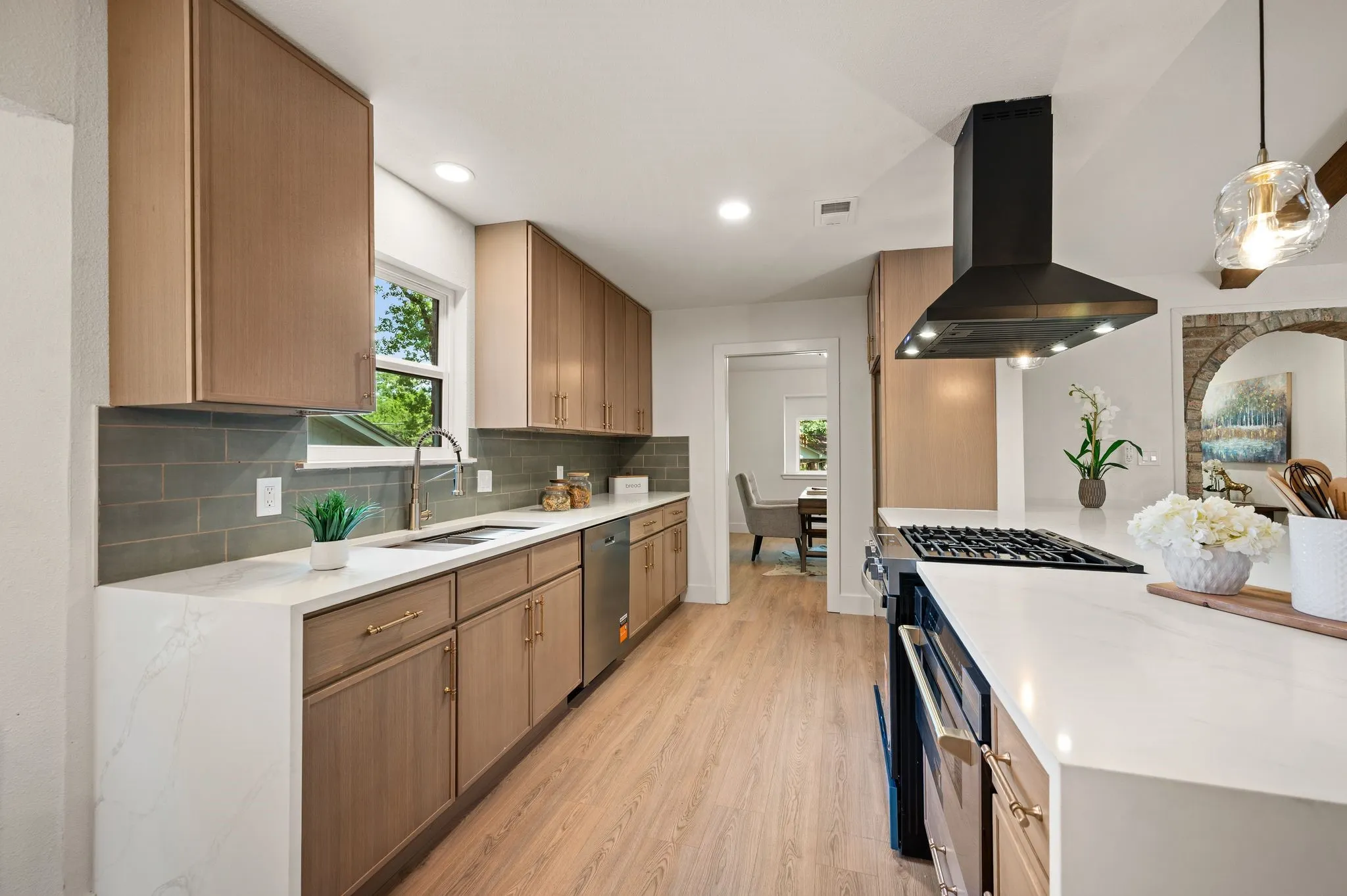 Custom slim-shaker oak Koville cabinetry and expansive counters deliver the storage and workspace serious cooks appreciate.