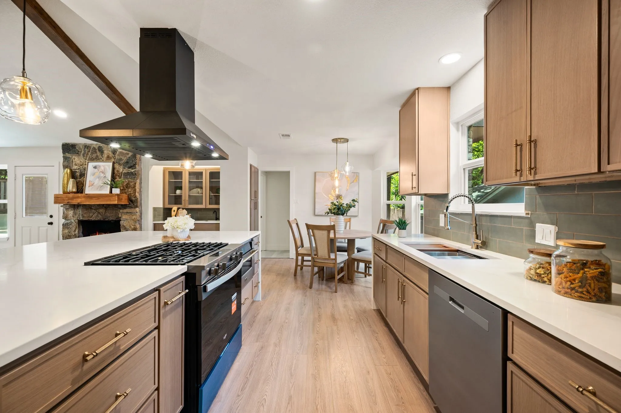 A black stainless undermount sink, champagne-bronze details, and warm cabinetry turn everyday tasks into a more elevated experience.