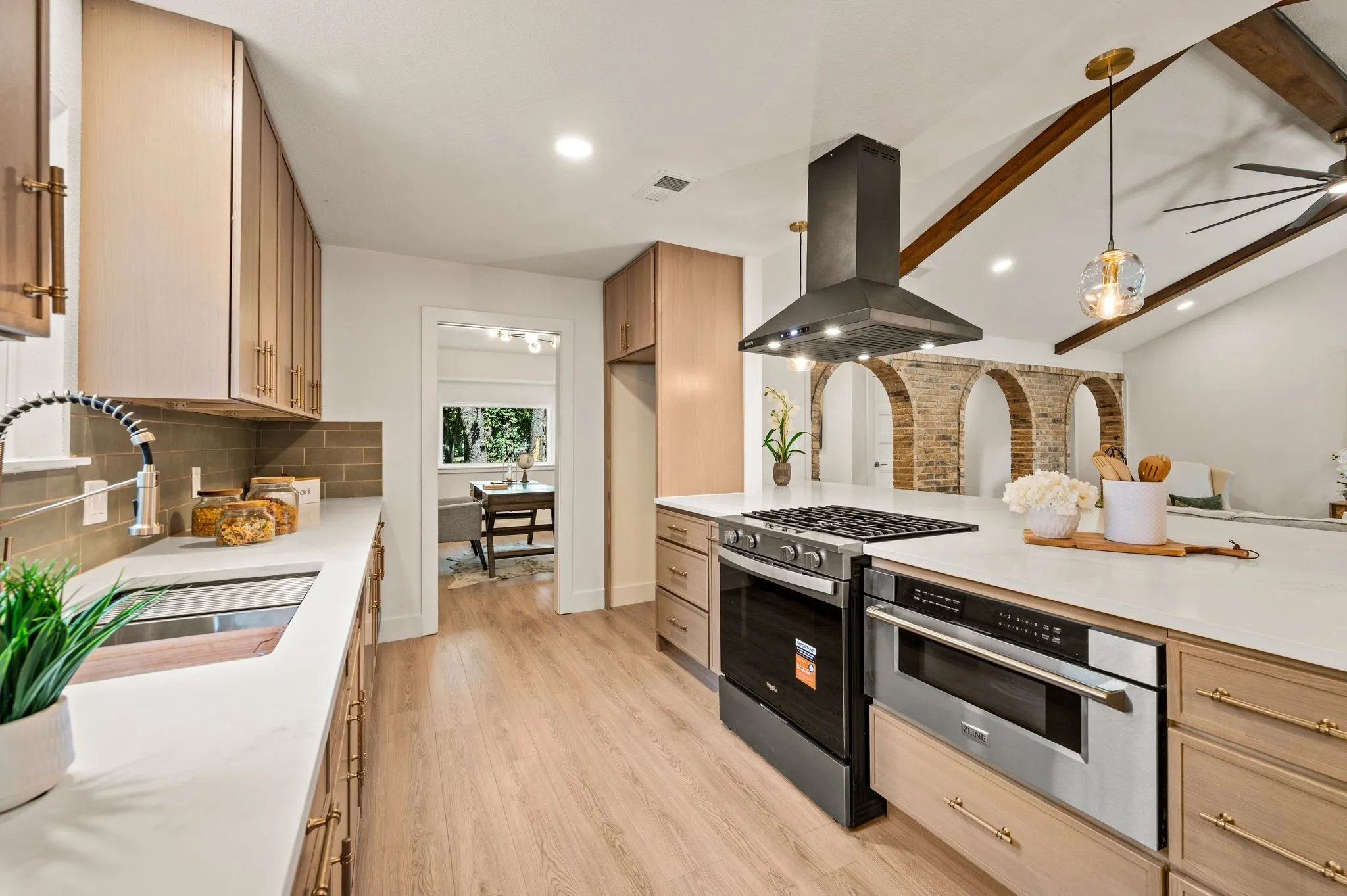 The chef-inspired kitchen pairs a gas range, ZLINE microwave drawer, designer hardware, and generous prep space.