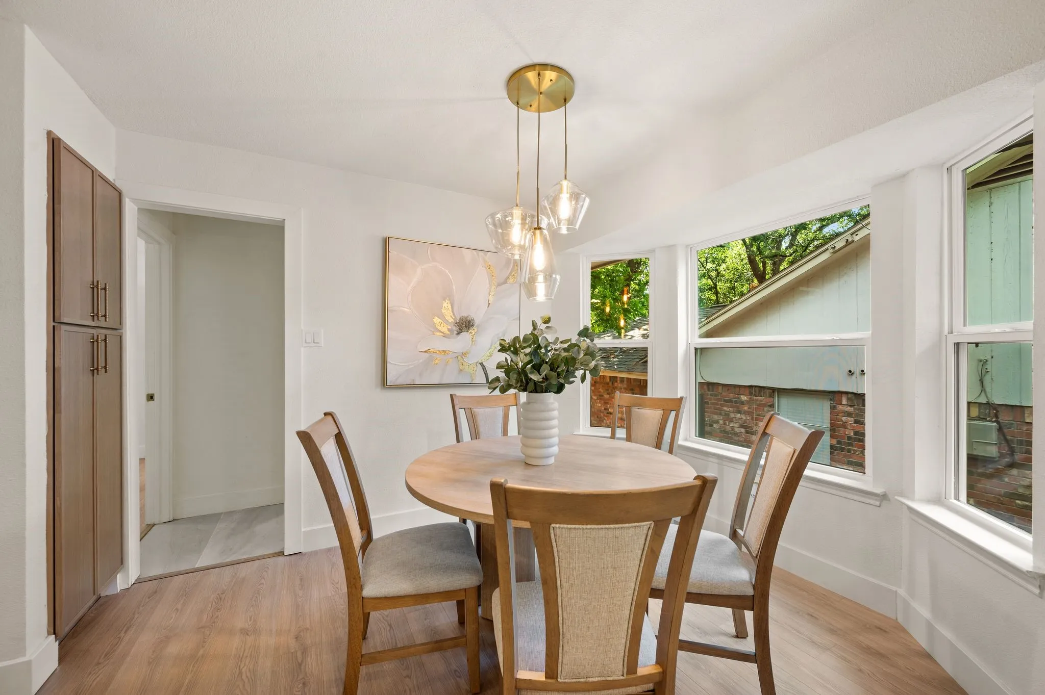 Wrapped in windows, the cozy breakfast nook is made for slow mornings and coffee beneath the trees.