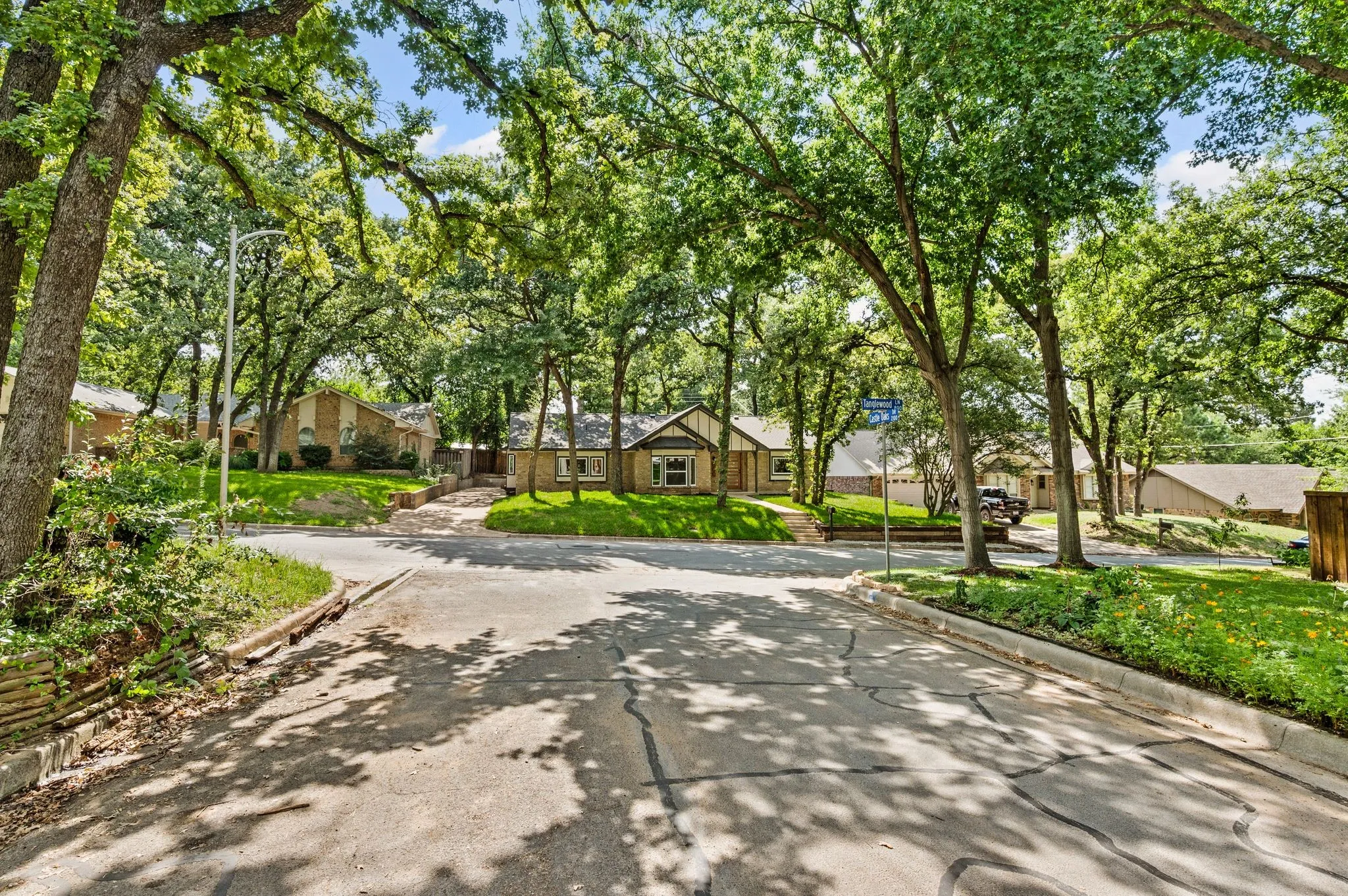A quiet, tree-lined street creates the kind of established neighborhood setting that feels removed yet remains centrally located.