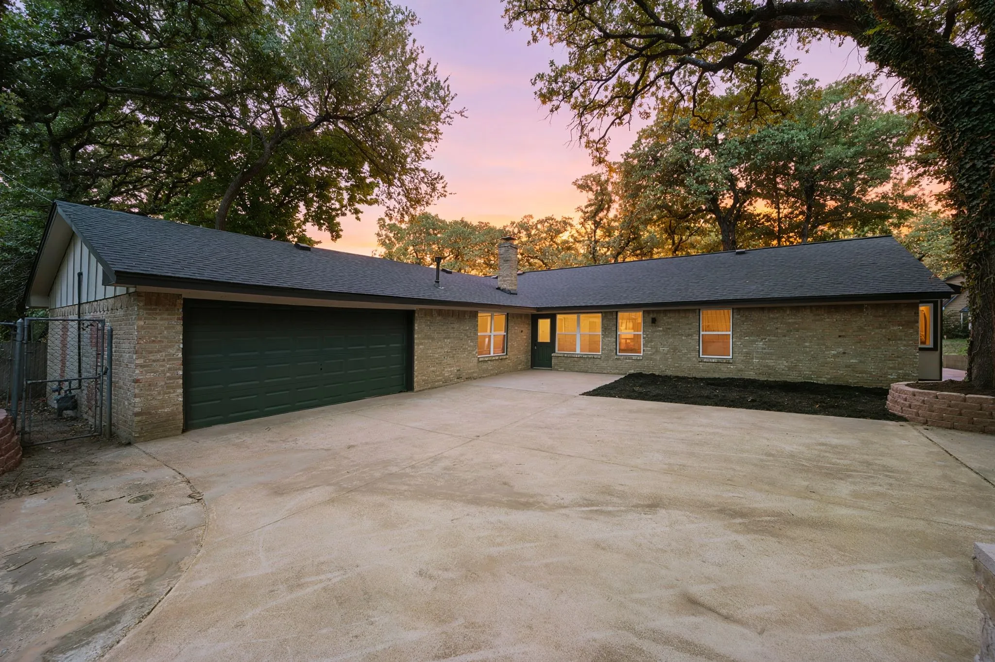 An expansive rear drive and attached garage provide exceptional parking, privacy, and everyday convenience.