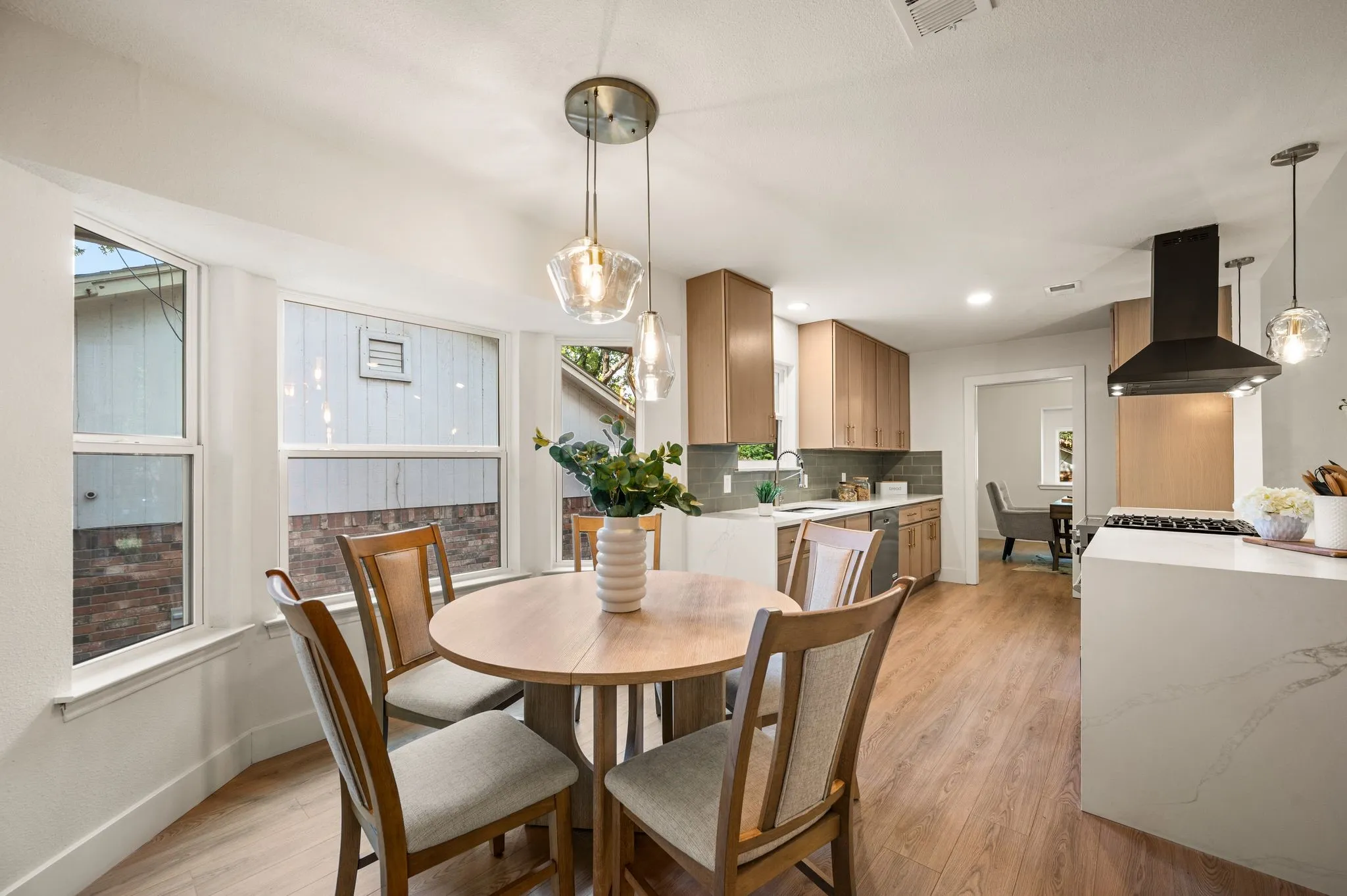 The breakfast nook flows directly into the kitchen, keeping everyday meals intimate and entertaining effortless.