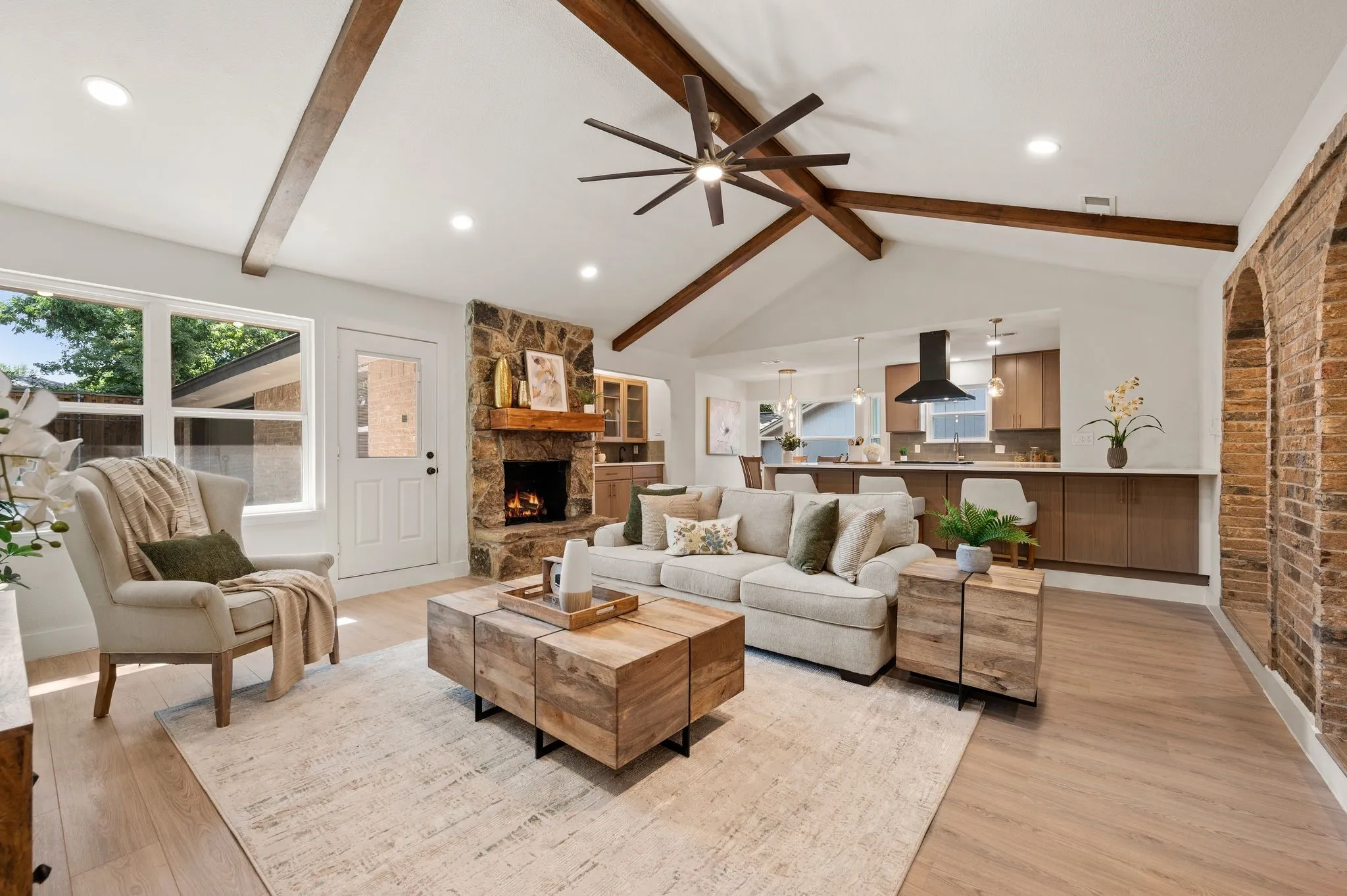 Vaulted ceilings, preserved architecture, and open sightlines bring the kitchen and living room together effortlessly.