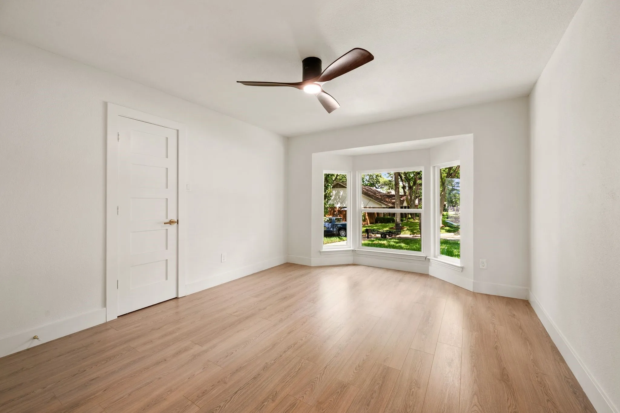Clean lines, updated doors, and warm flooring give this bedroom a polished yet comfortable feel.