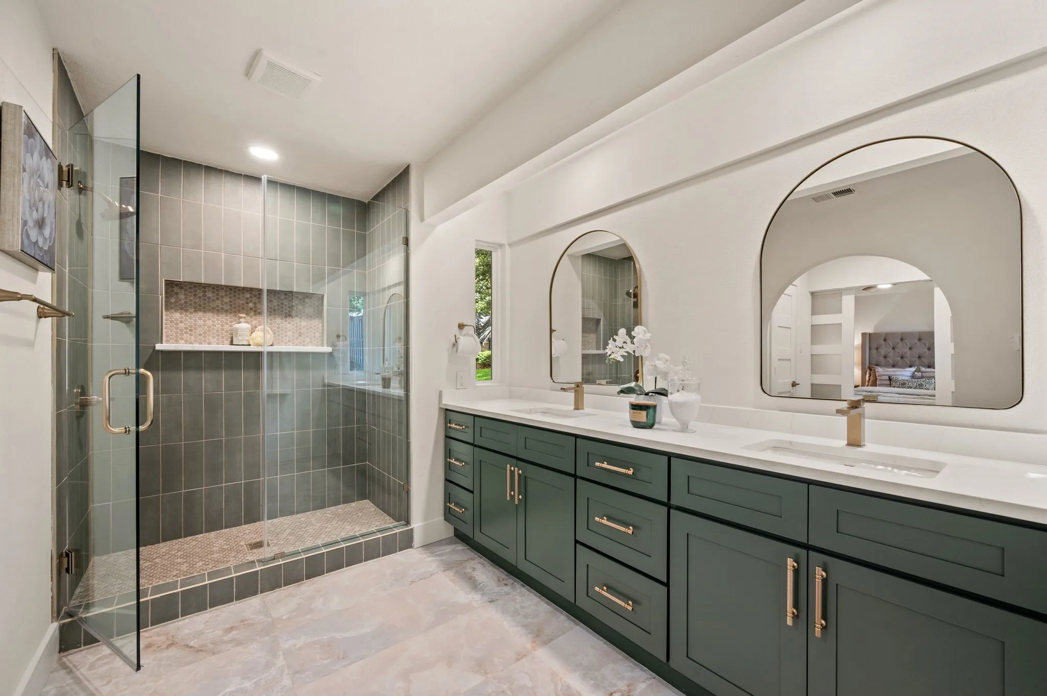 The primary bath pairs an expansive double vanity with a frameless, fully tiled shower for a refined daily retreat.