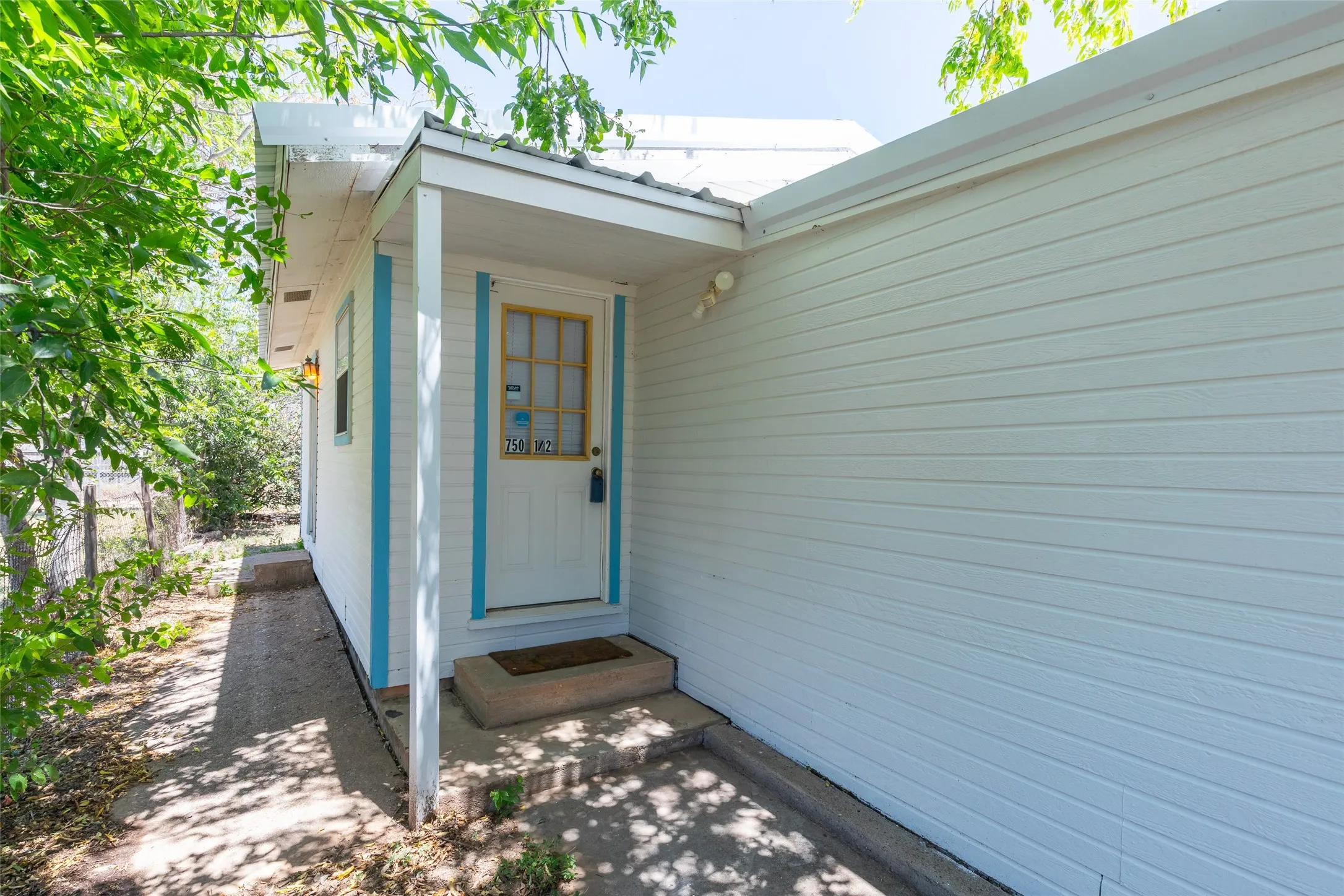 White horizontal siding exterior featuring a covered entry porch