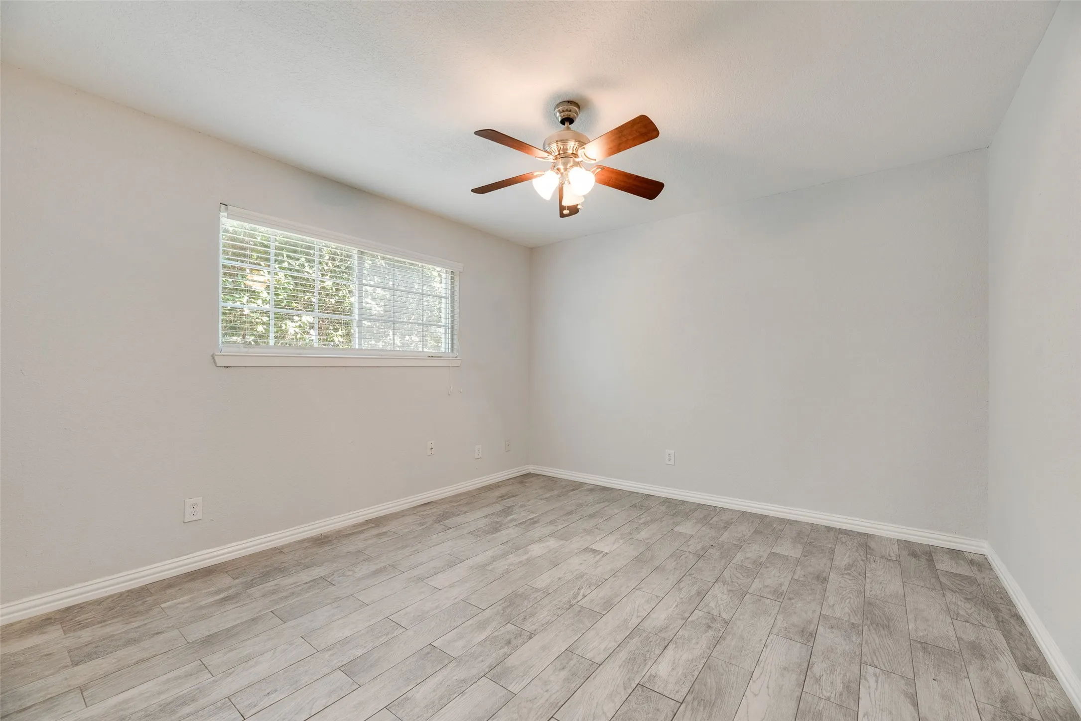 Neutral-toned room featuring light wood-finish flooring