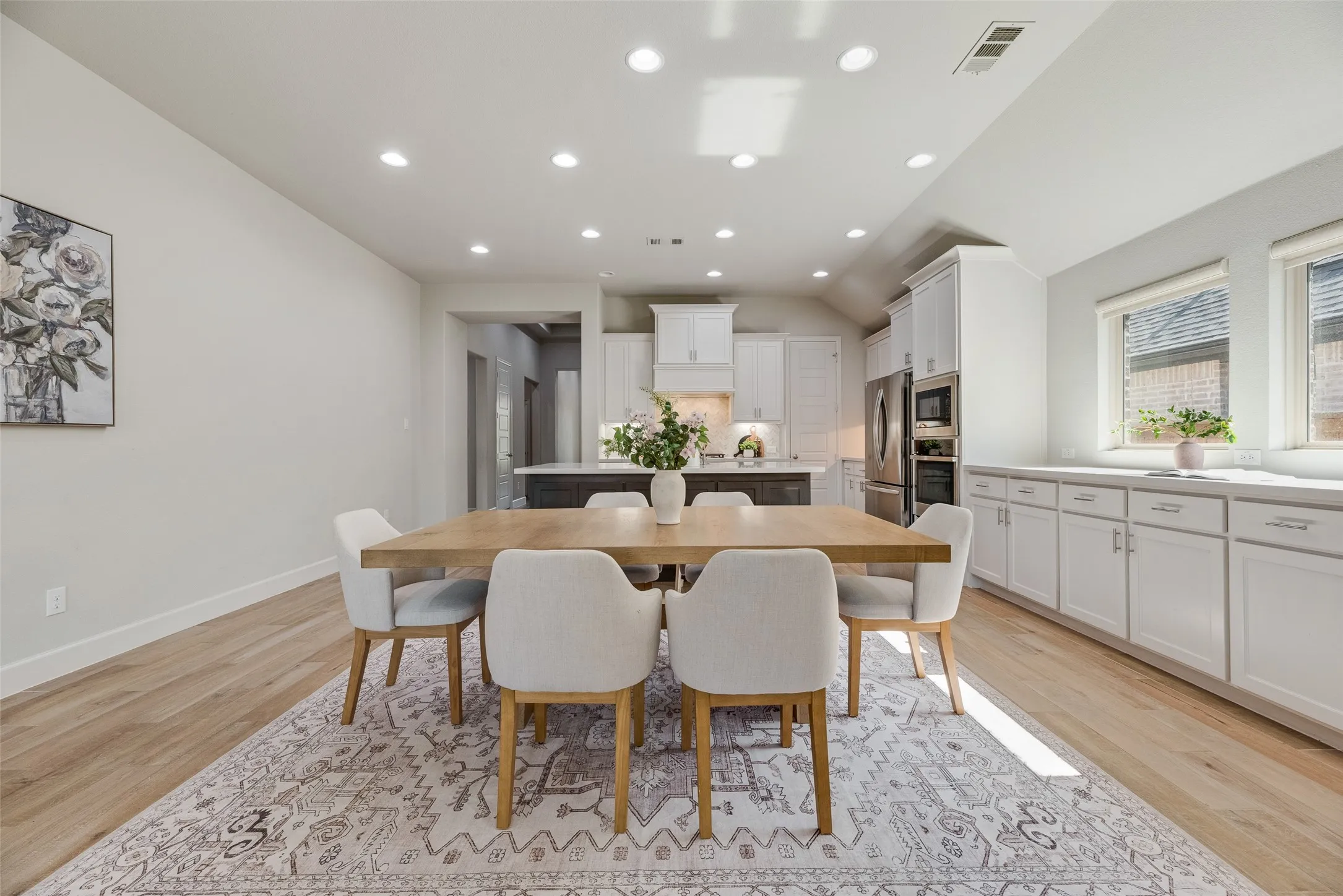 Dining area featuring wood-finish flooring, recessed lighting, and extending countertop and cabinet storage