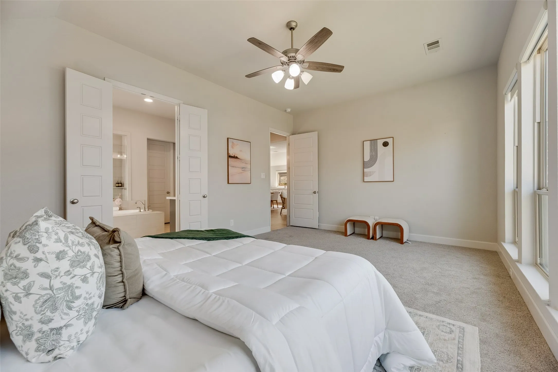 Expansive room featuring light gray carpet flooring and multiple large windows