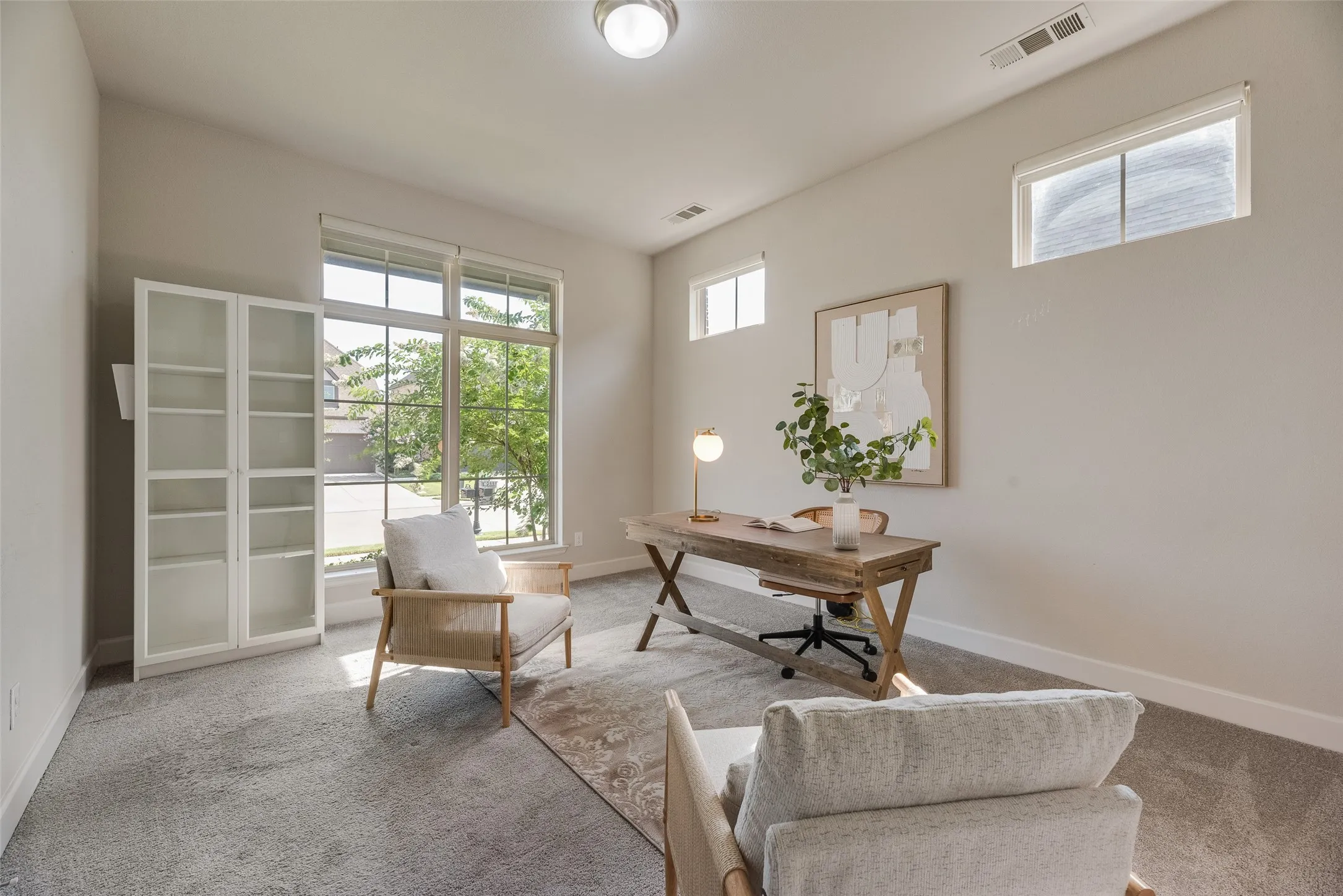 Spacious office is just off the foyer for added privacy for at home work and features large window and transoms for added natural light and French doors