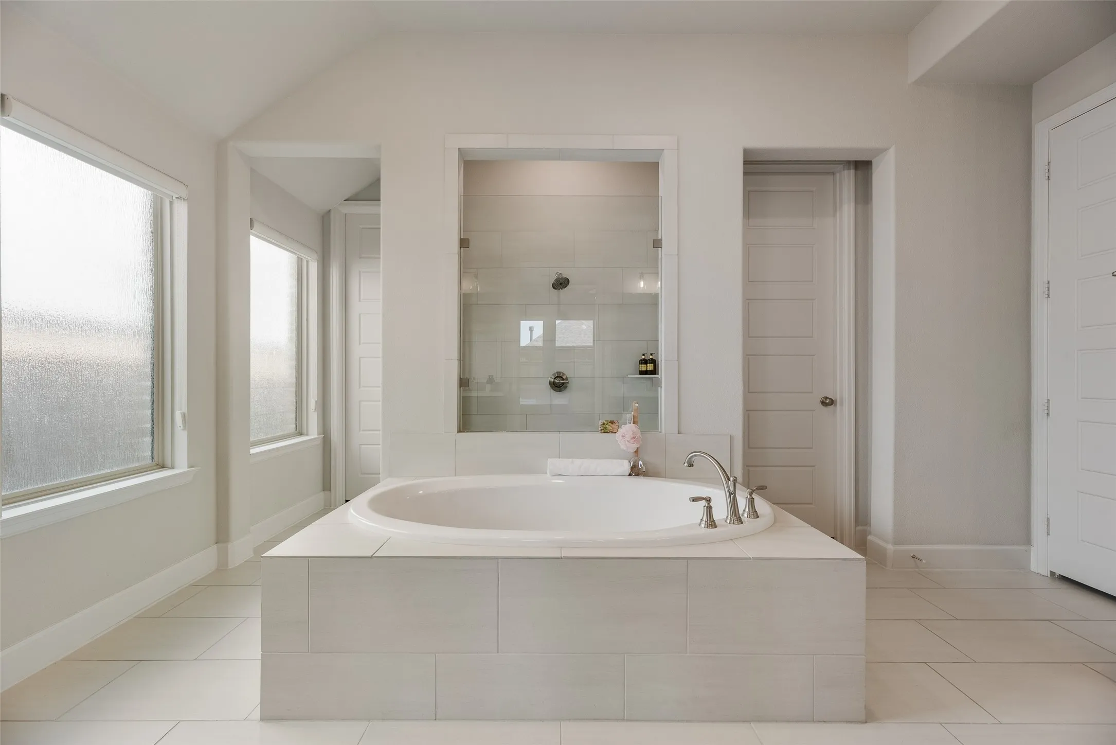 Soaking garden tube in this spacious primary spa like bathroom overlooks in to walk in shower