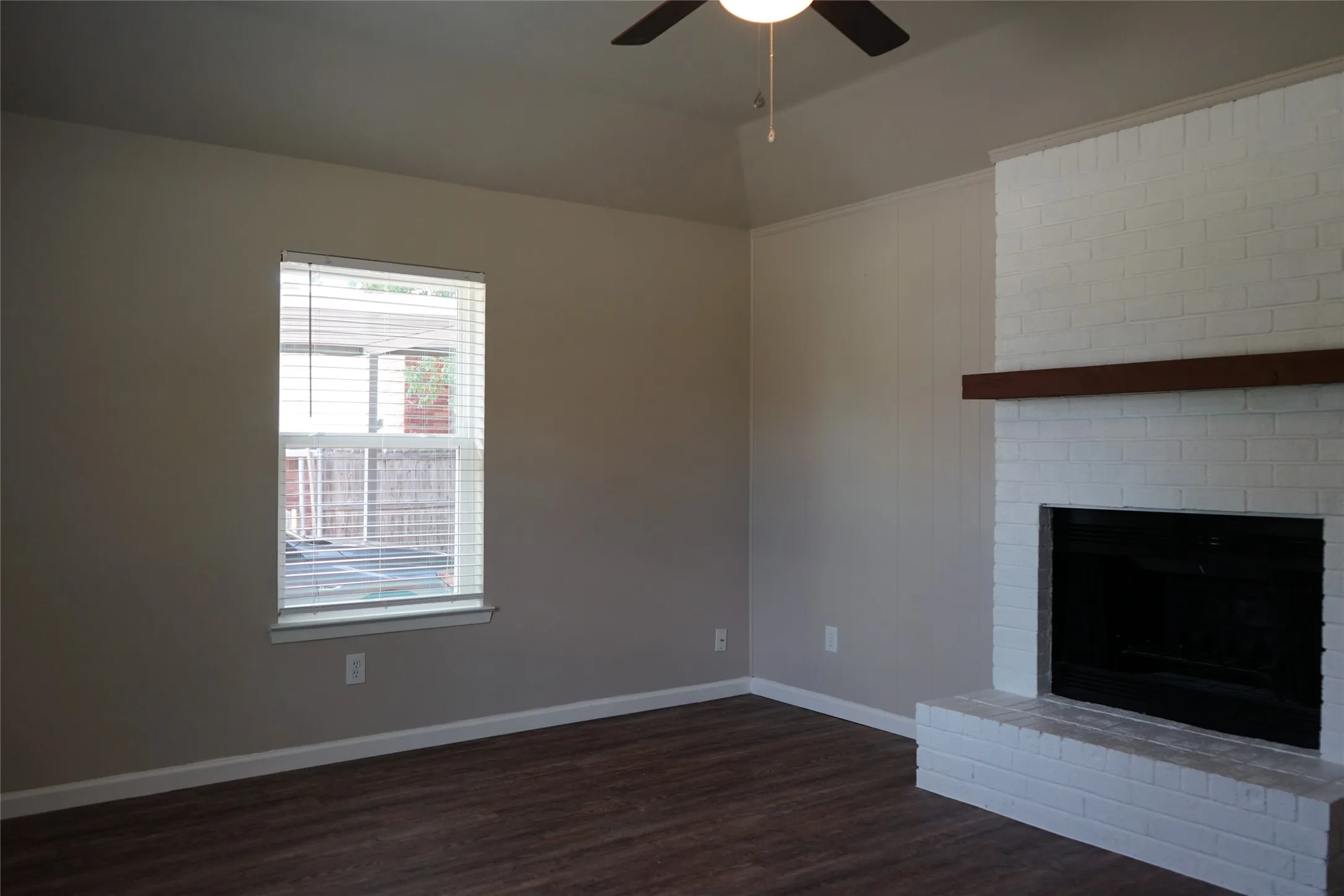 Ceiling fan and fireplace in the den