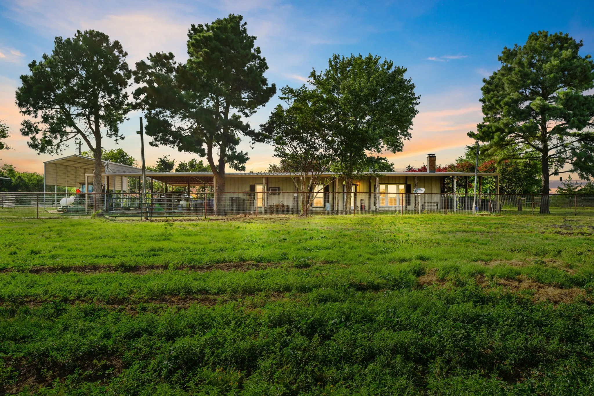 Arena directly behind home and grass has grown in