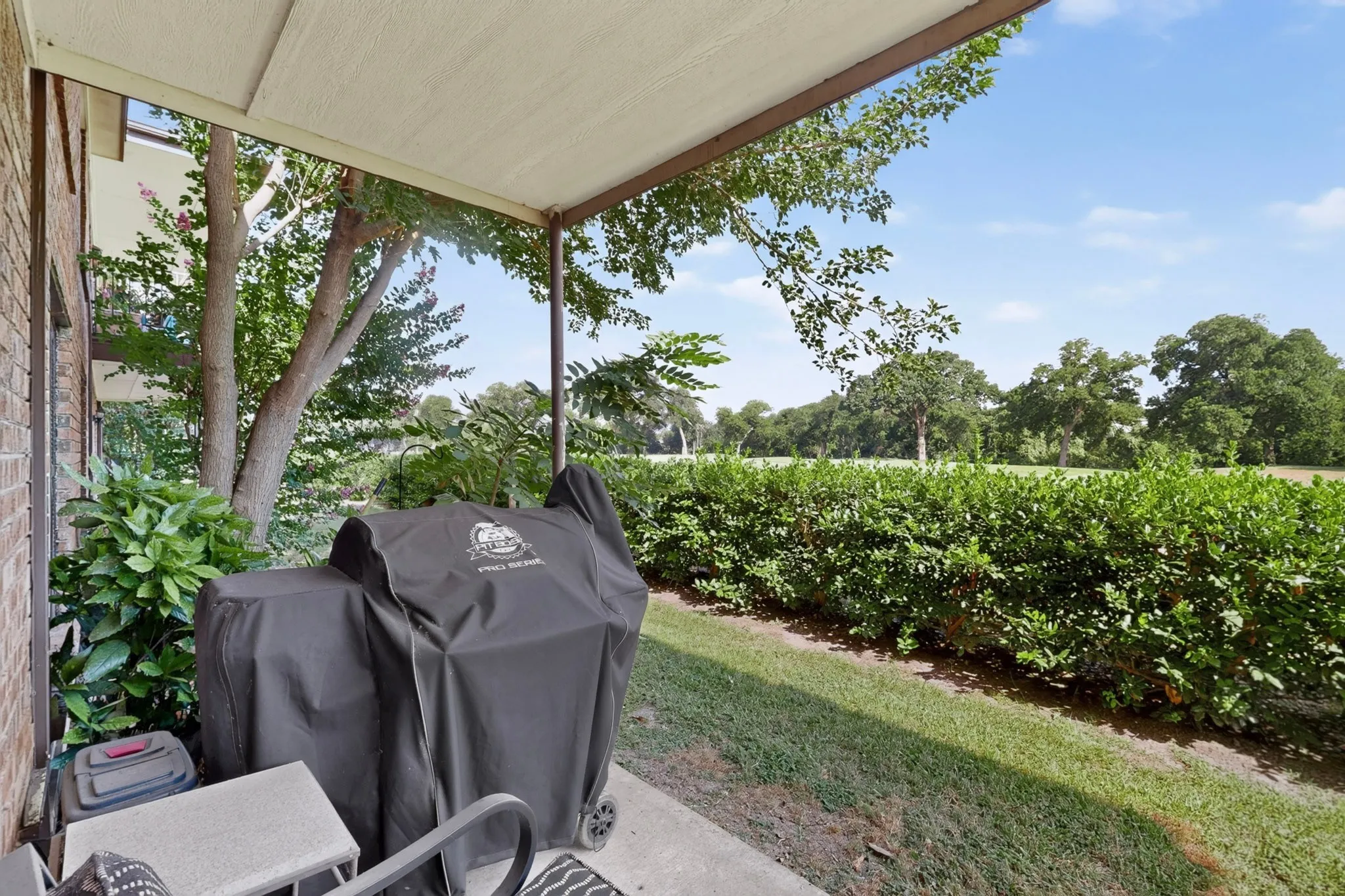Covered patio with a view of the 18th hole