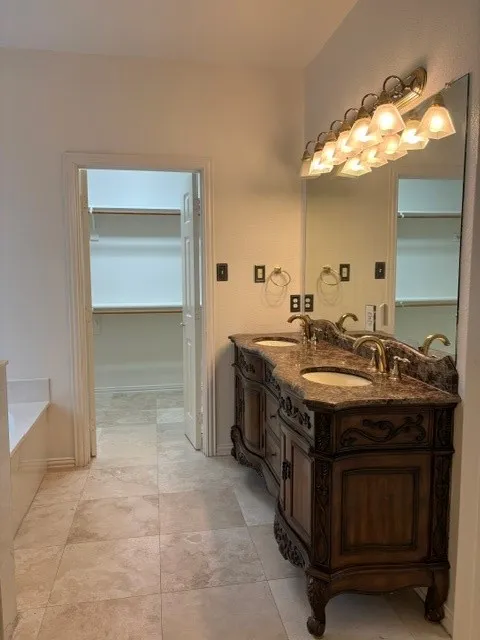 Dual vanity with integrated sinks and a stone-finish countertop