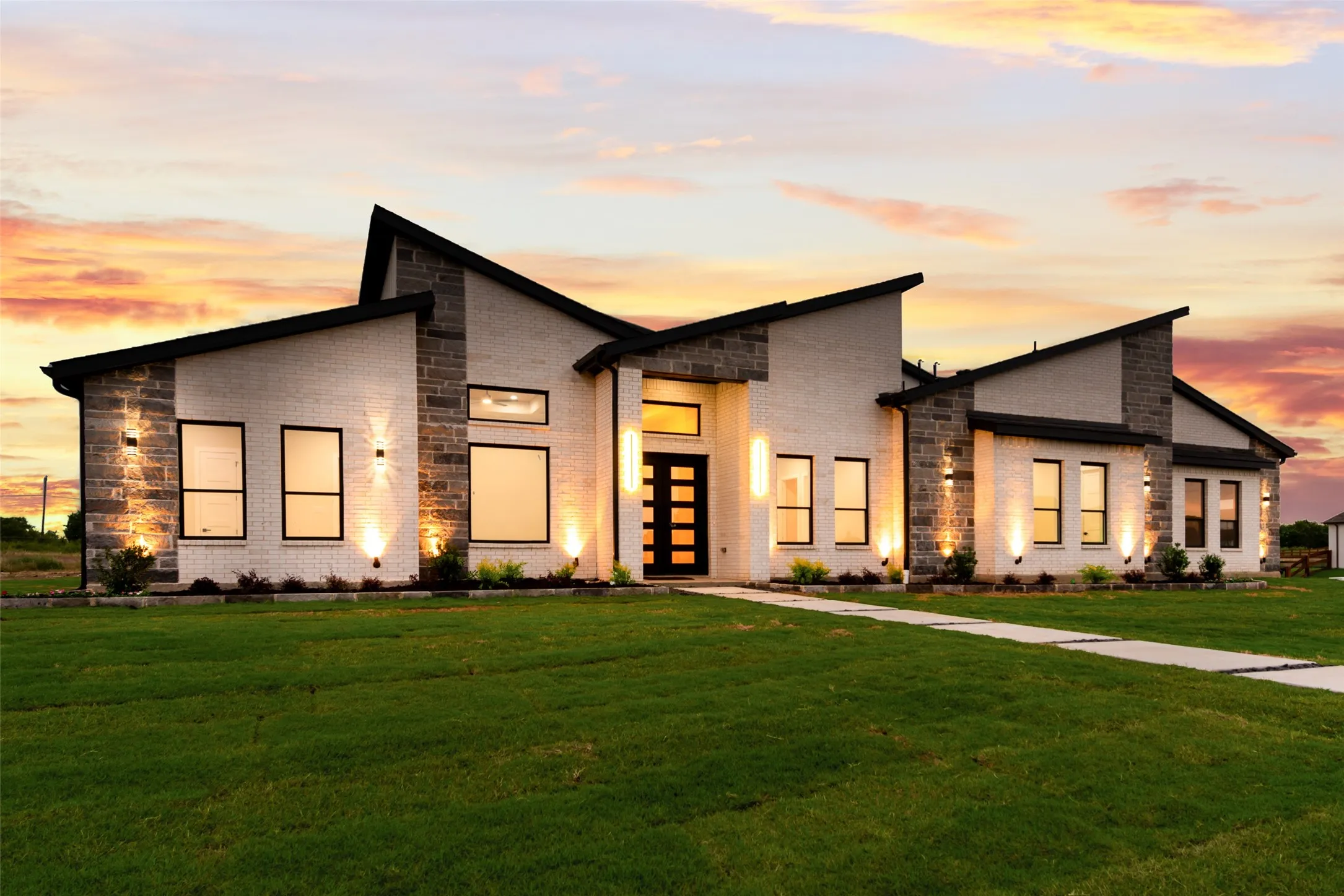 Modern architectural exterior featuring a combination of light-colored brick and stone accents