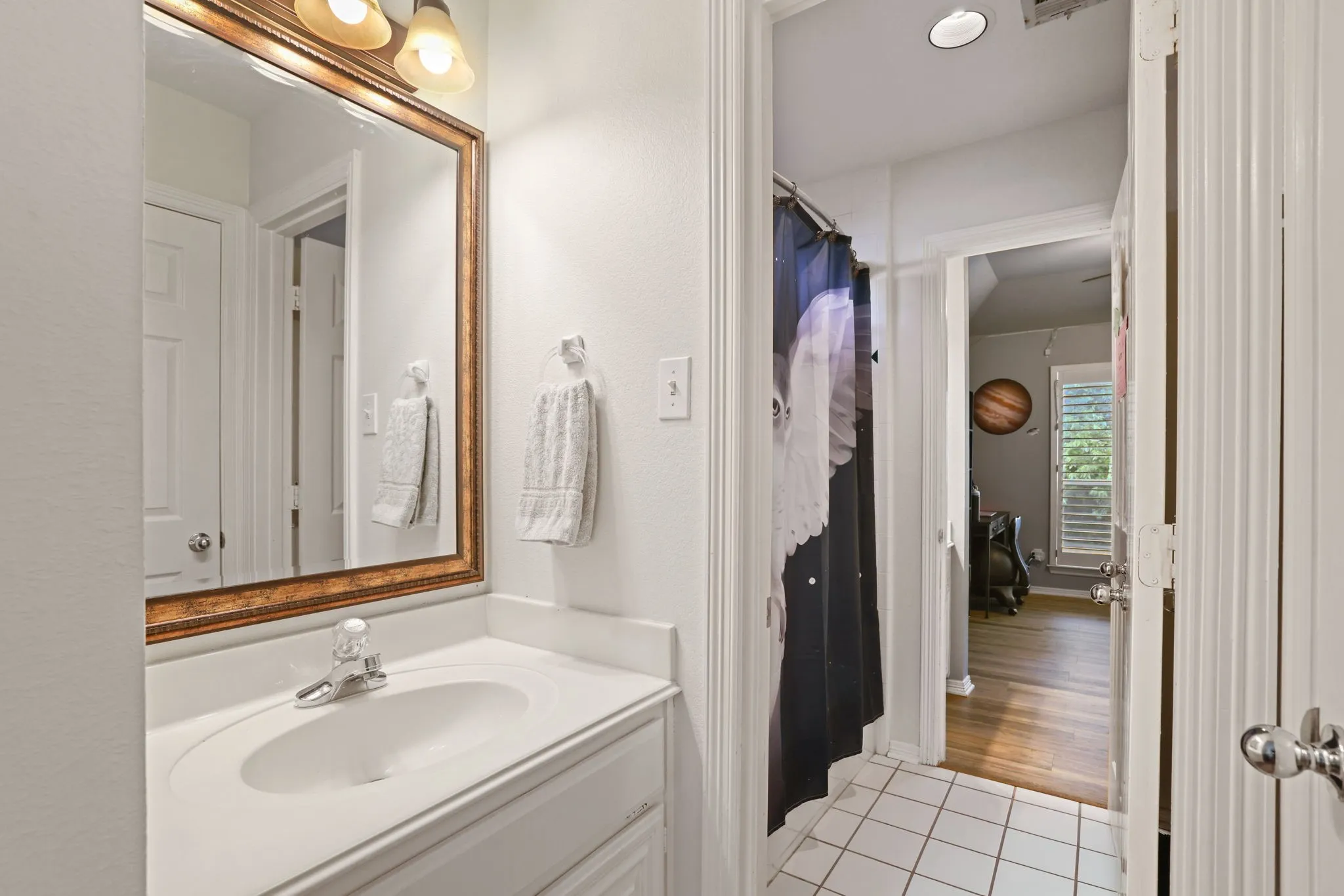 White vanity with an integrated sink and chrome faucet
