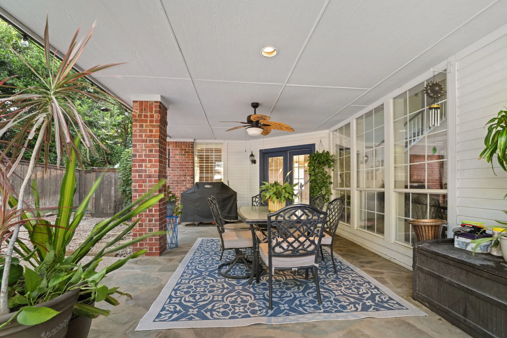 Covered patio featuring slate flooring, a ceiling fan, recessed lighting, brick pillars, and French doors
